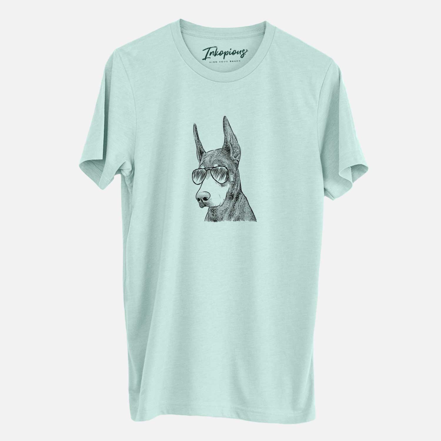 Hand-drawn sketch of Sunny the Doberman Pinscher wearing aviator sunglasses on a Heather Sage Unisex crewneck