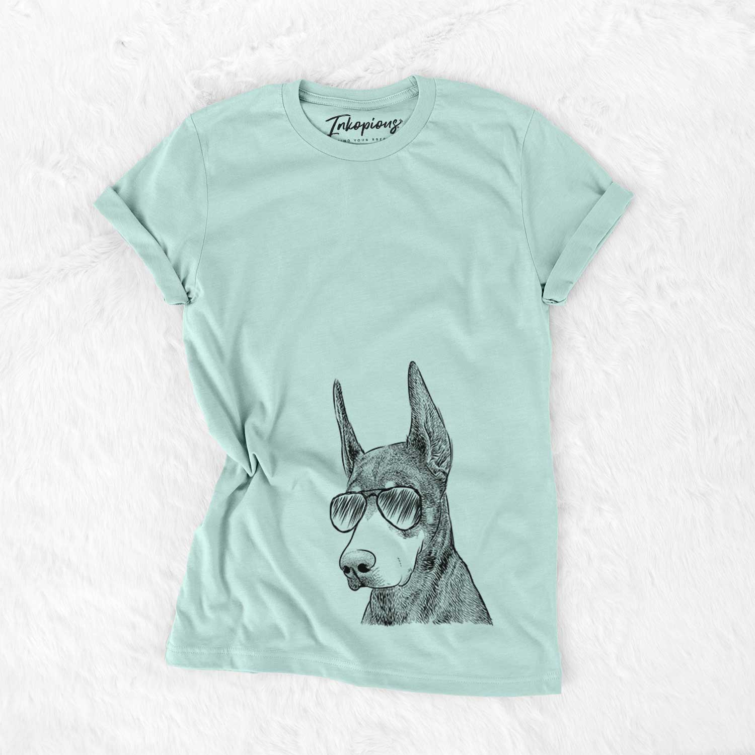 Hand-drawn sketch of Sunny the Doberman Pinscher wearing aviator sunglasses on a Heather Sage Unisex crewneck