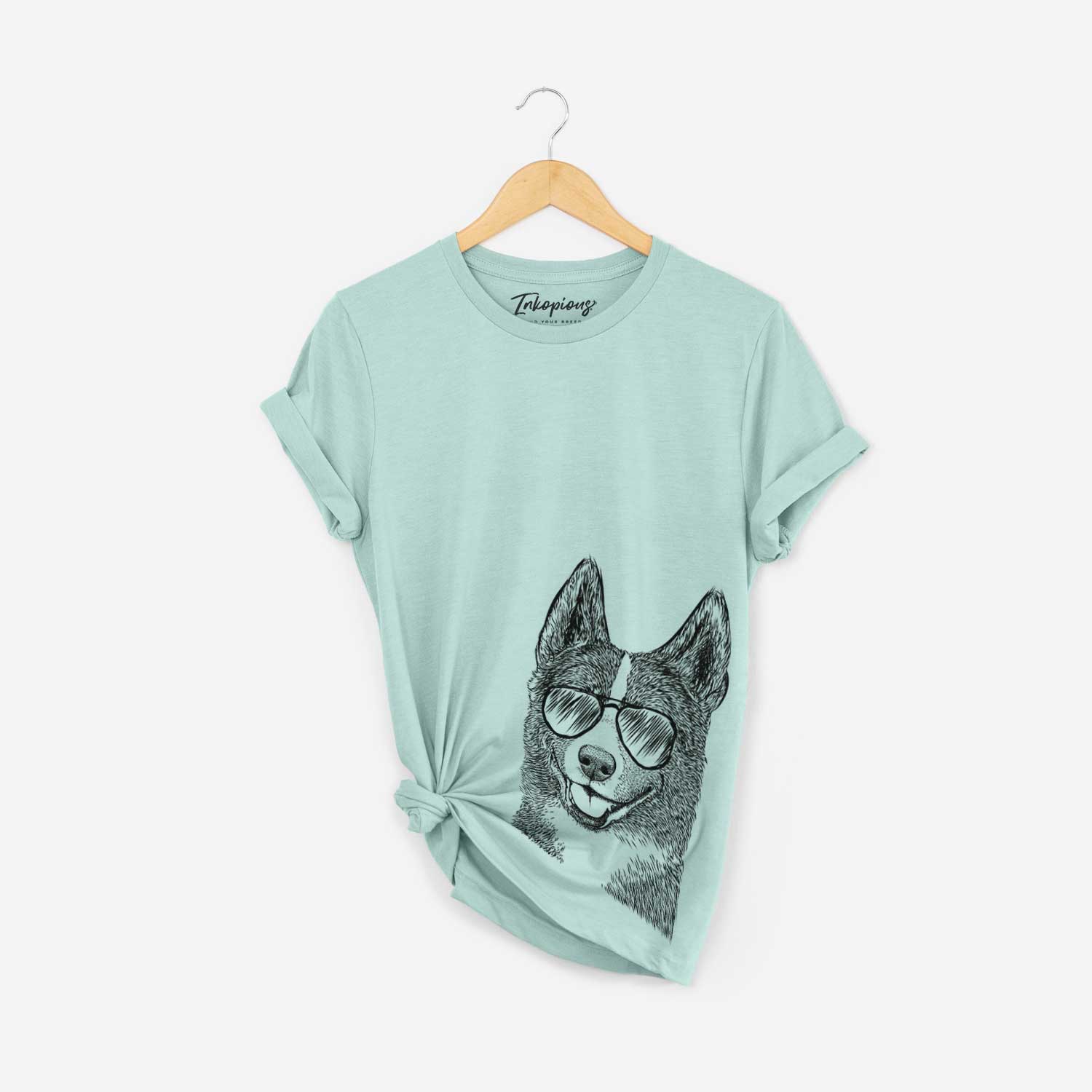 Hand-drawn sketch of Tosca the Karelian Bear Dog wearing aviator sunglasses on a Heather Sage Bella Canvas Unisex Crewneck