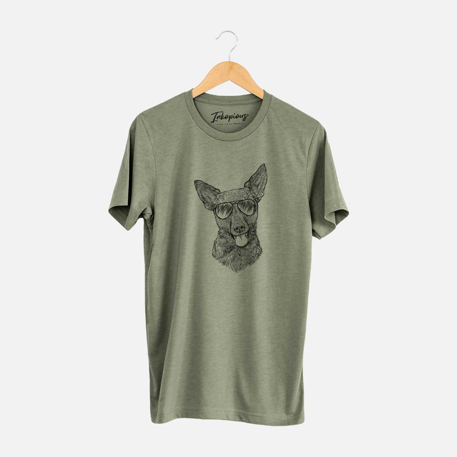 Hand-drawn sketch of Ursa the Mixed Breed wearing aviator sunglasses on an Olive Unisex crewneck