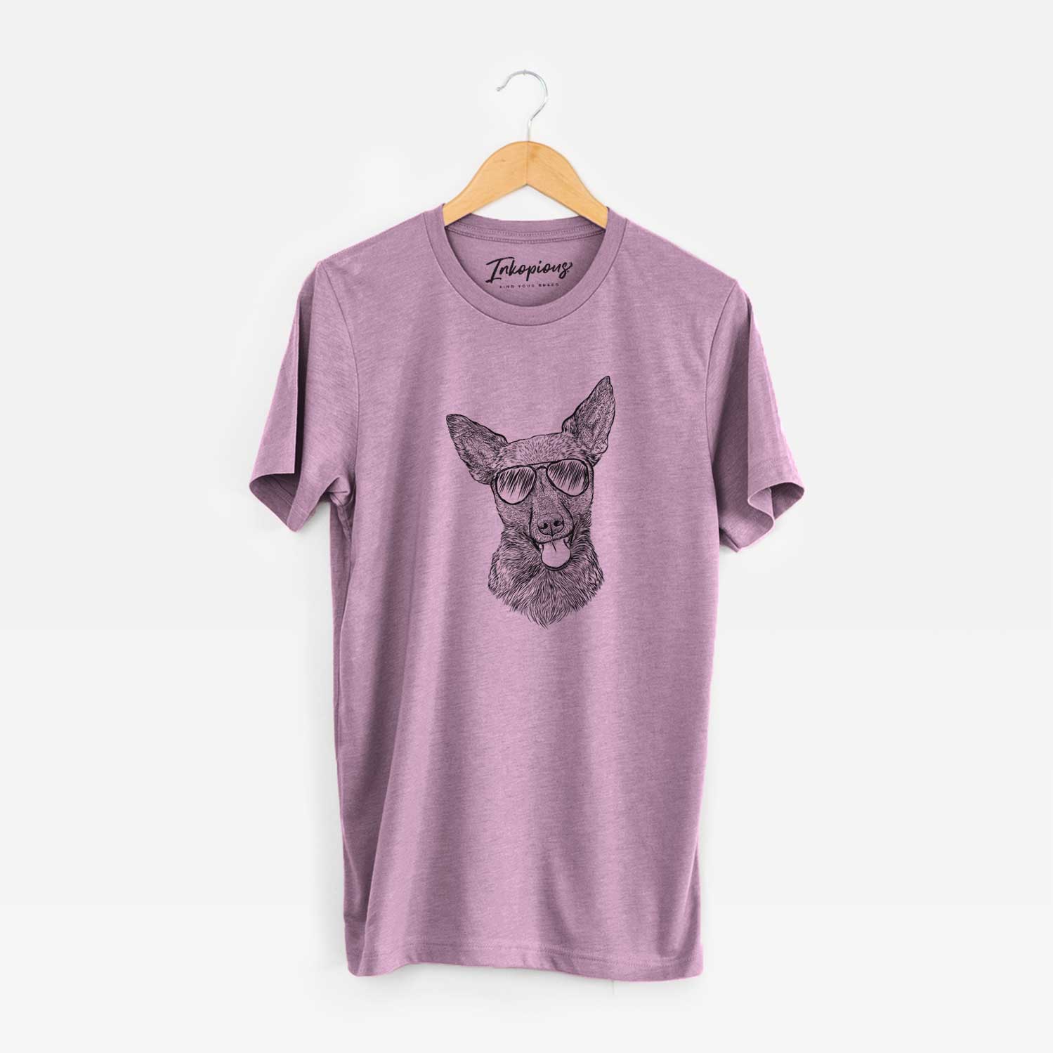 Hand-drawn sketch of Ursa the Mixed Breed wearing aviator sunglasses on an Orchid Unisex crewneck