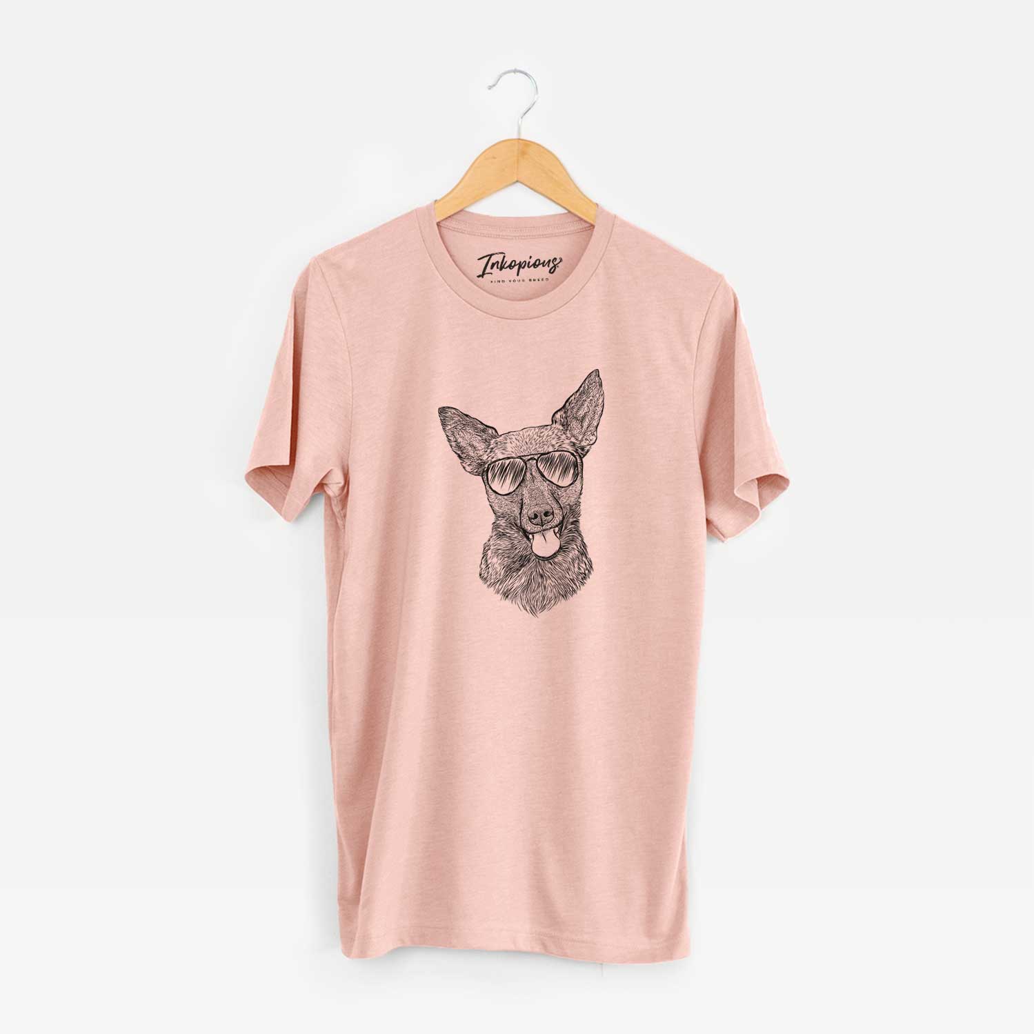 Hand-drawn sketch of Ursa the Mixed Breed wearing aviator sunglasses on a Peach Unisex crewneck
