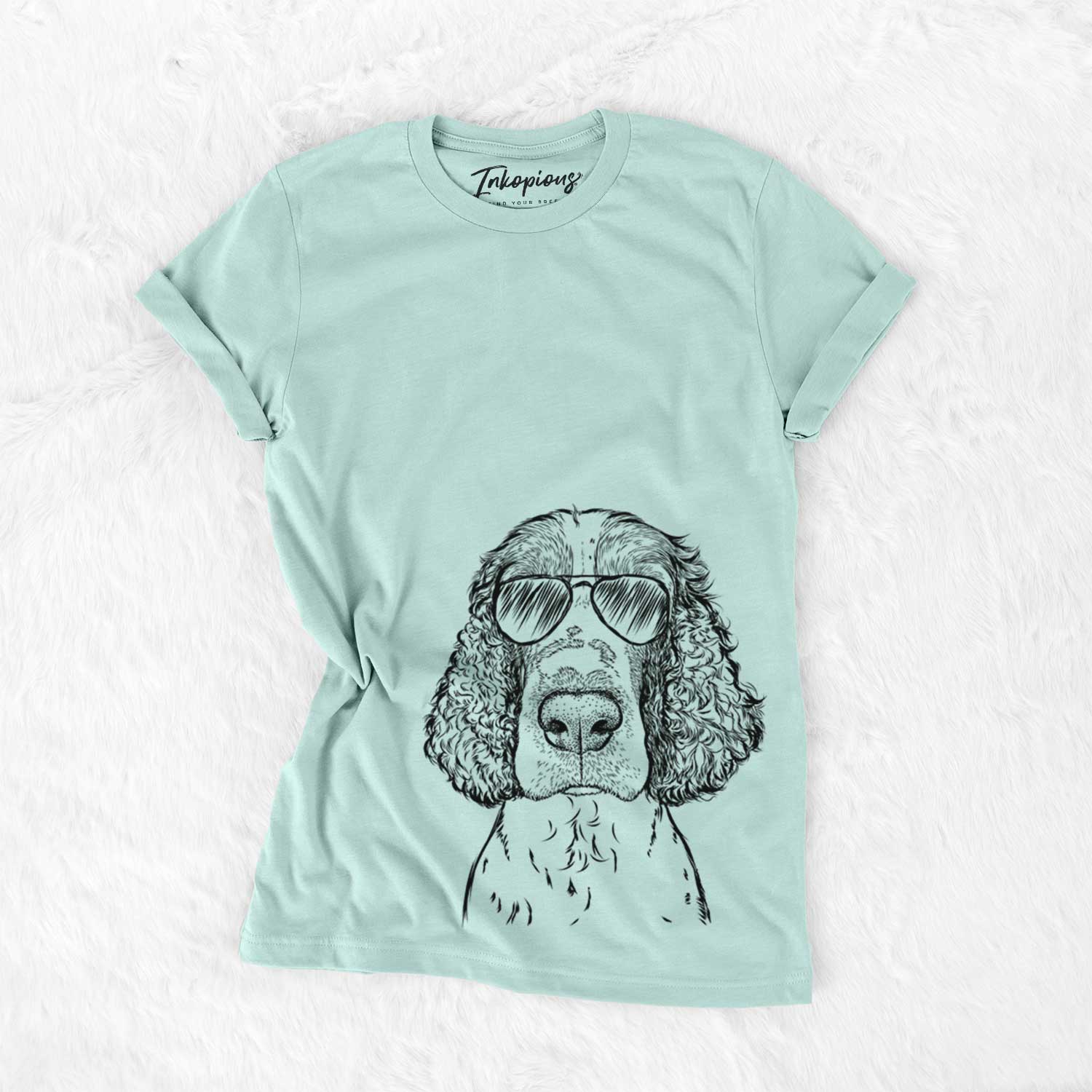 Hand-drawn sketch of Wilbur the English Springer Spaniel wearing aviator sunglasses on a Heather Sage Unisex crewneck