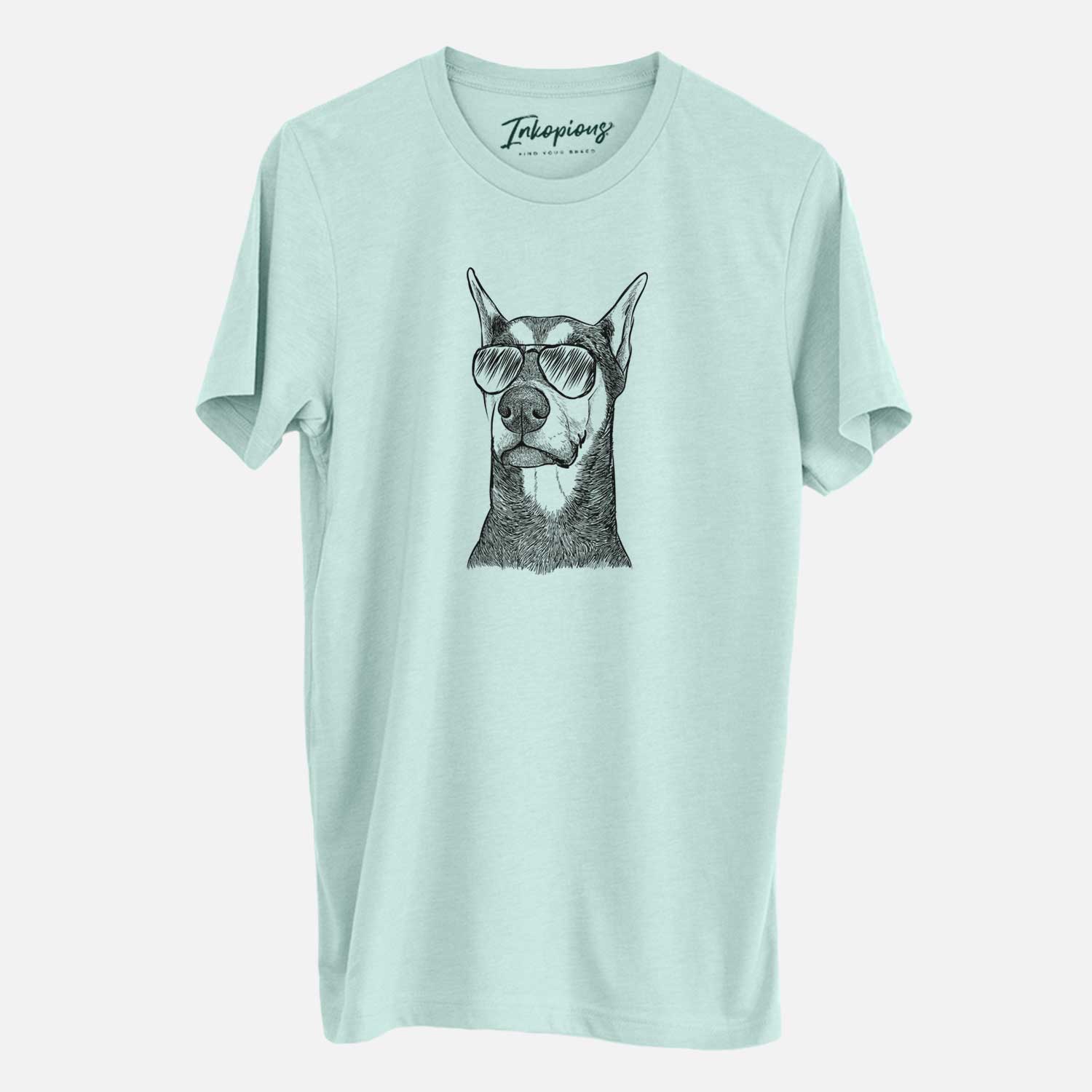 Hand-drawn sketch of Zeus the Doberman Pinscher wearing aviator sunglasses on a Heather Sage Unisex crewneck