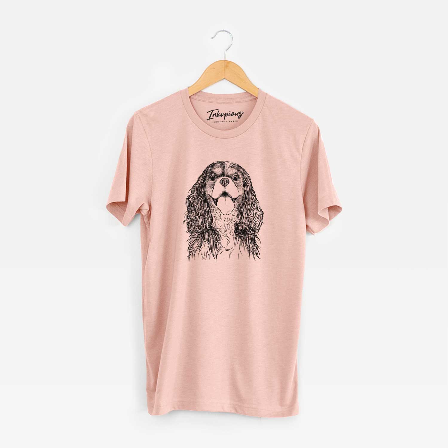 Hand-drawn sketch of Brandy the Cavalier King Charles Spaniel on a Peach Unisex crewneck
