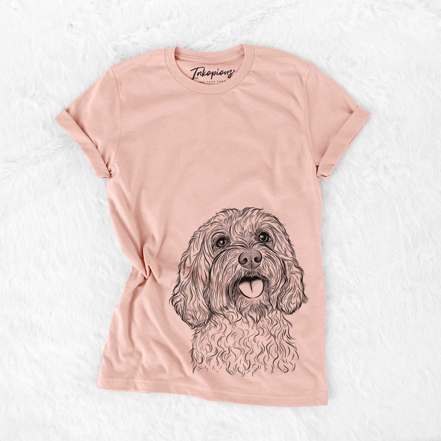 Hand-drawn sketch of Cali the Cavapoo on a Peach Bella Canvas Unisex Crewneck