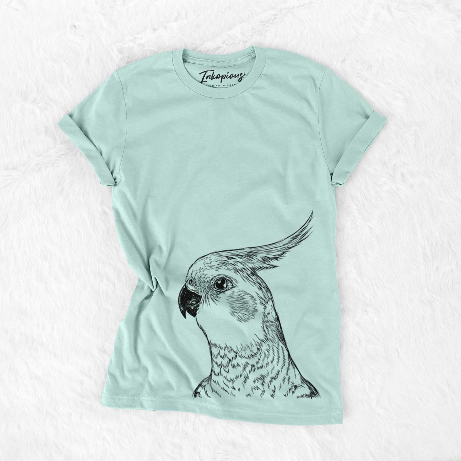 Hand-drawn sketch of Candy the Cockatiel on a Heather Sage Bella Canvas Unisex Crewneck