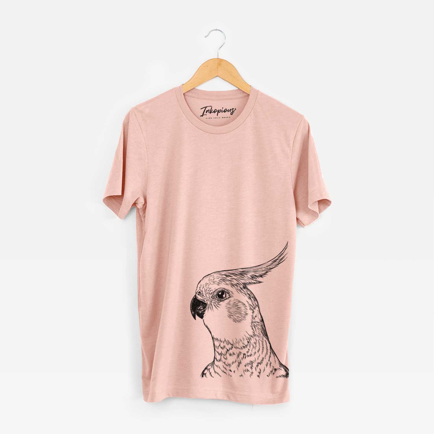 Hand-drawn sketch of Candy the Cockatiel on a Peach Bella Canvas Unisex Crewneck