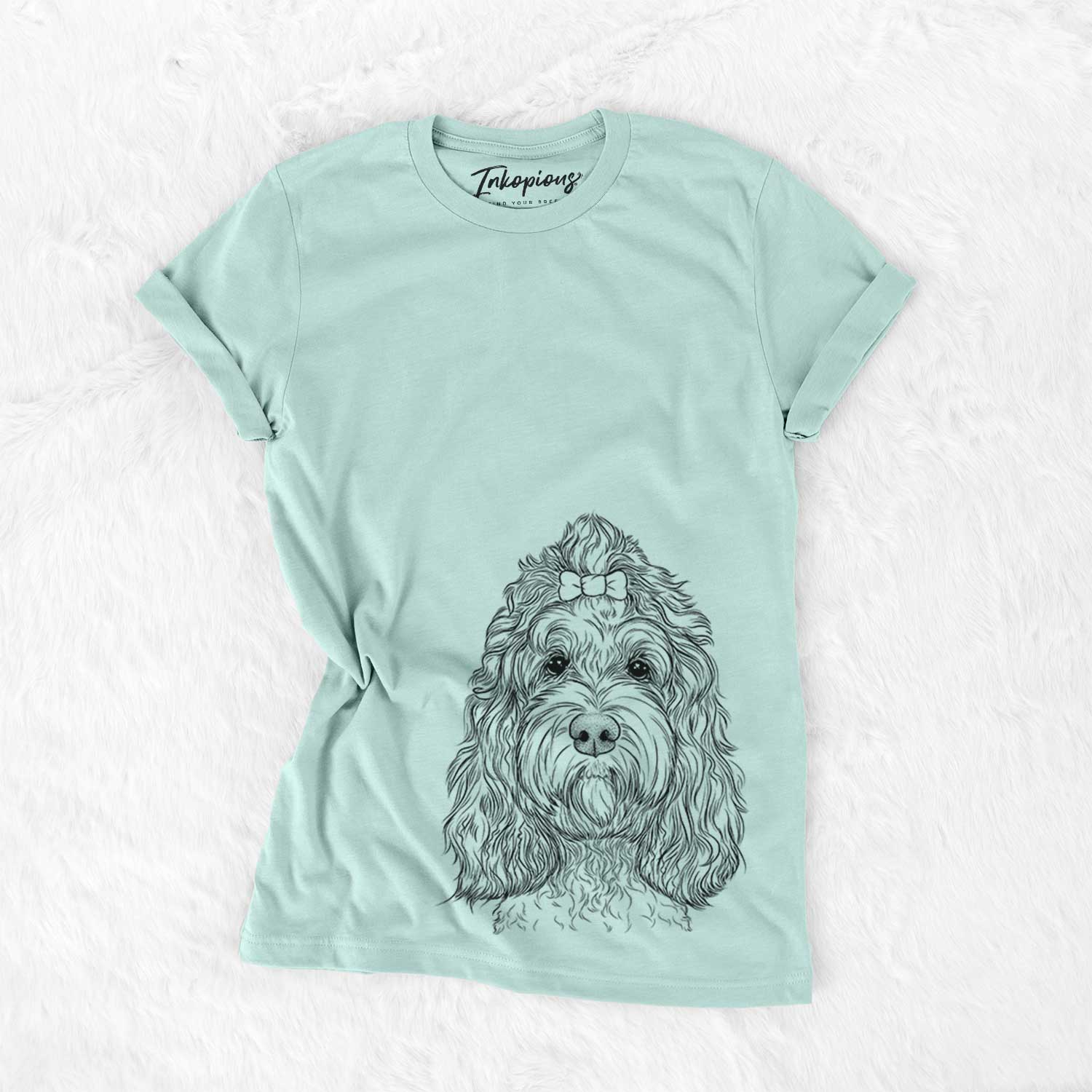 Hand-drawn sketch of Chloe the Cockapoo on a Heather Sage Unisex crewneck