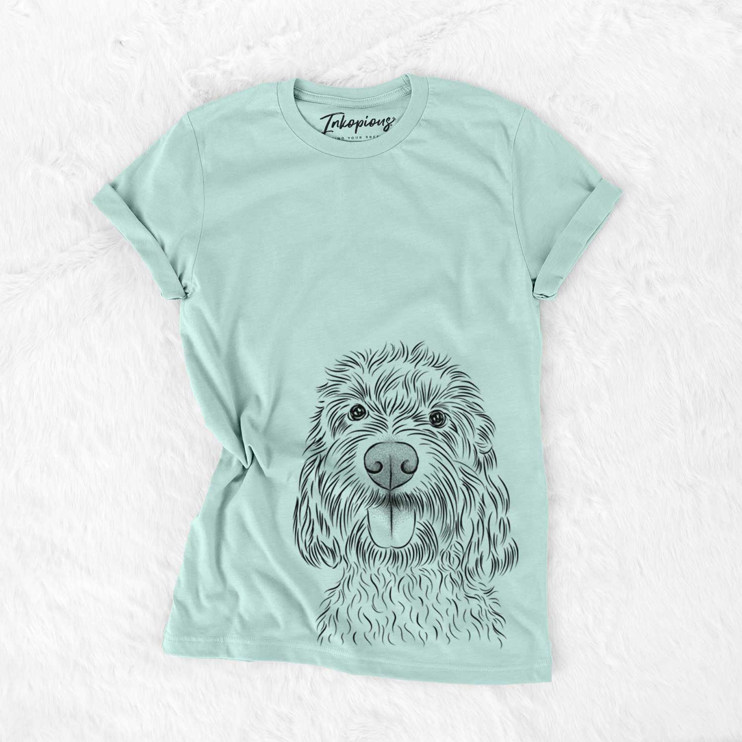 Hand-drawn sketch of Clover the Cockapoo on a Heather Sage Unisex crewneck