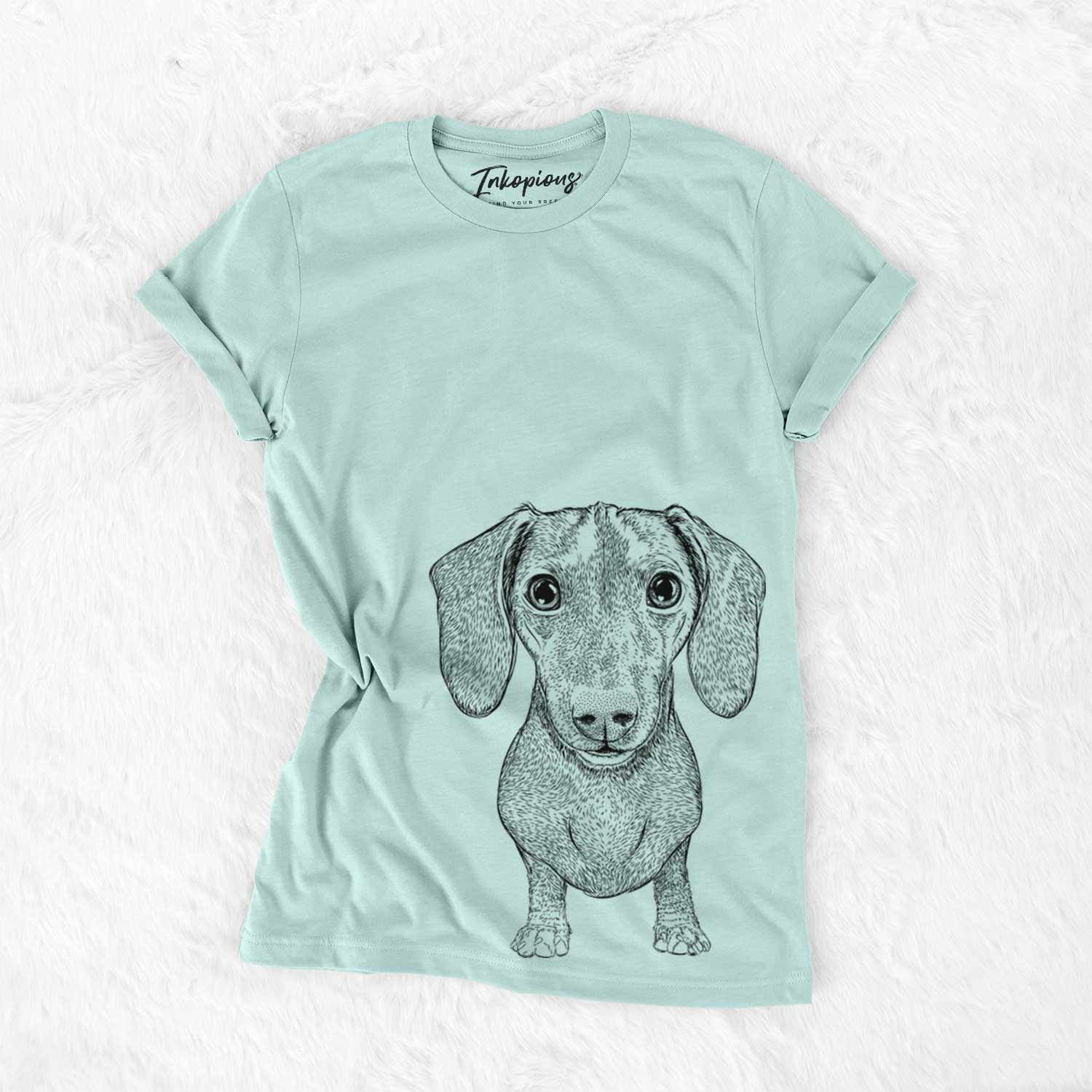 Hand-drawn sketch of Ernie the Mini Dachshund on a Heather Sage Unisex crewneck