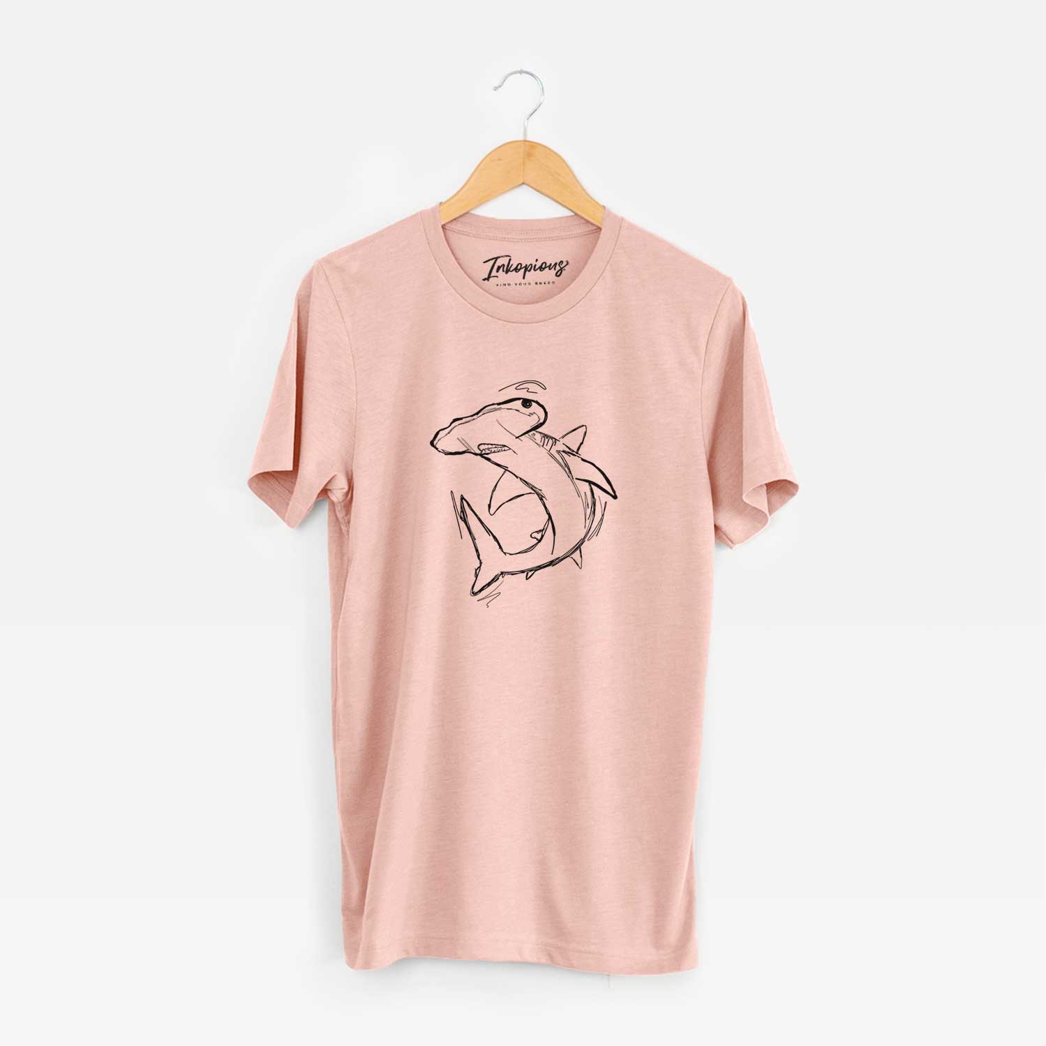 Hand-drawn sketch of Hank the Hammerhead Shark on a Peach Bella Canvas Unisex Crewneck