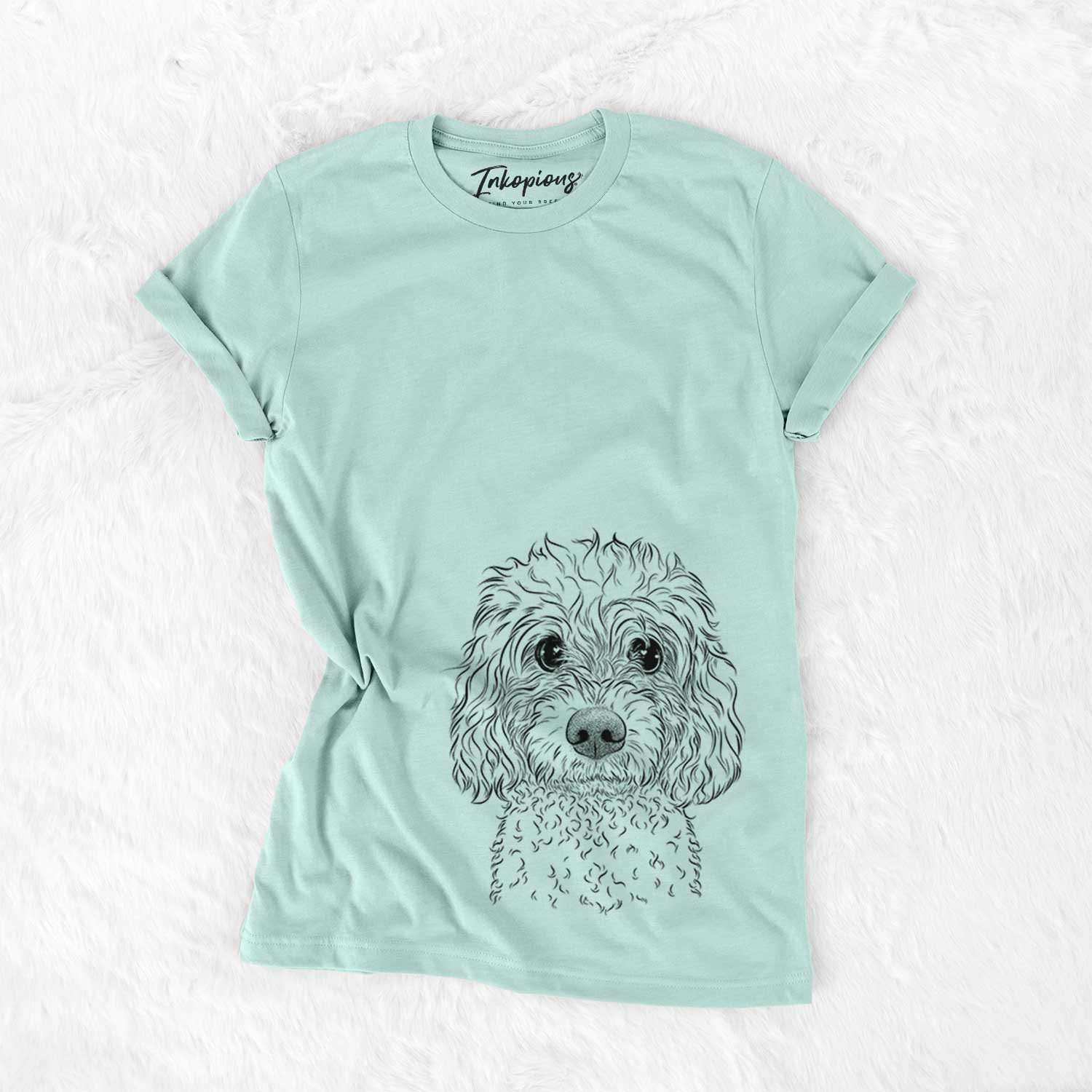 Hand-drawn sketch of Izzie the Cavachon on a Heather Sage Unisex crewneck