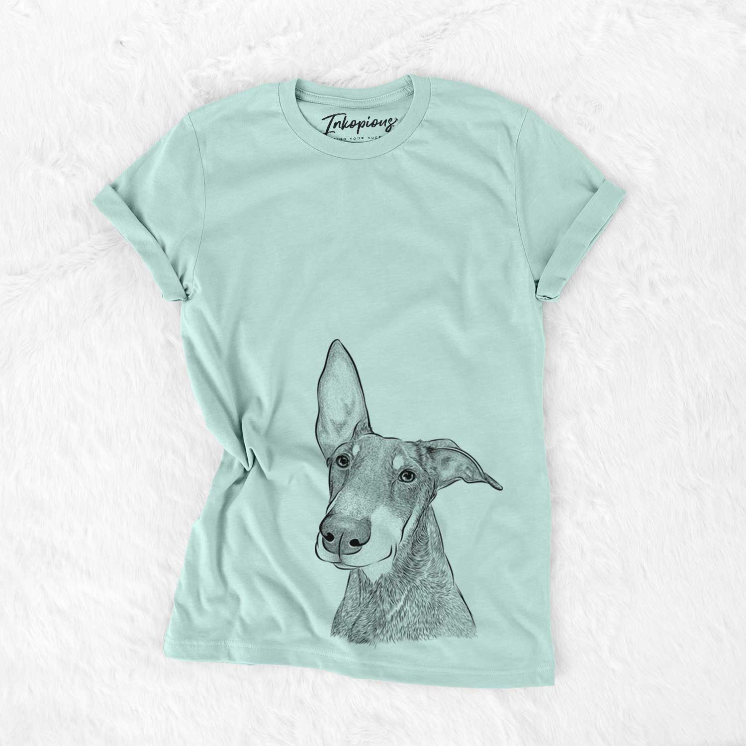 Hand-drawn sketch of Kain the Doberman Pinscher on a Heather Sage Unisex crewneck
