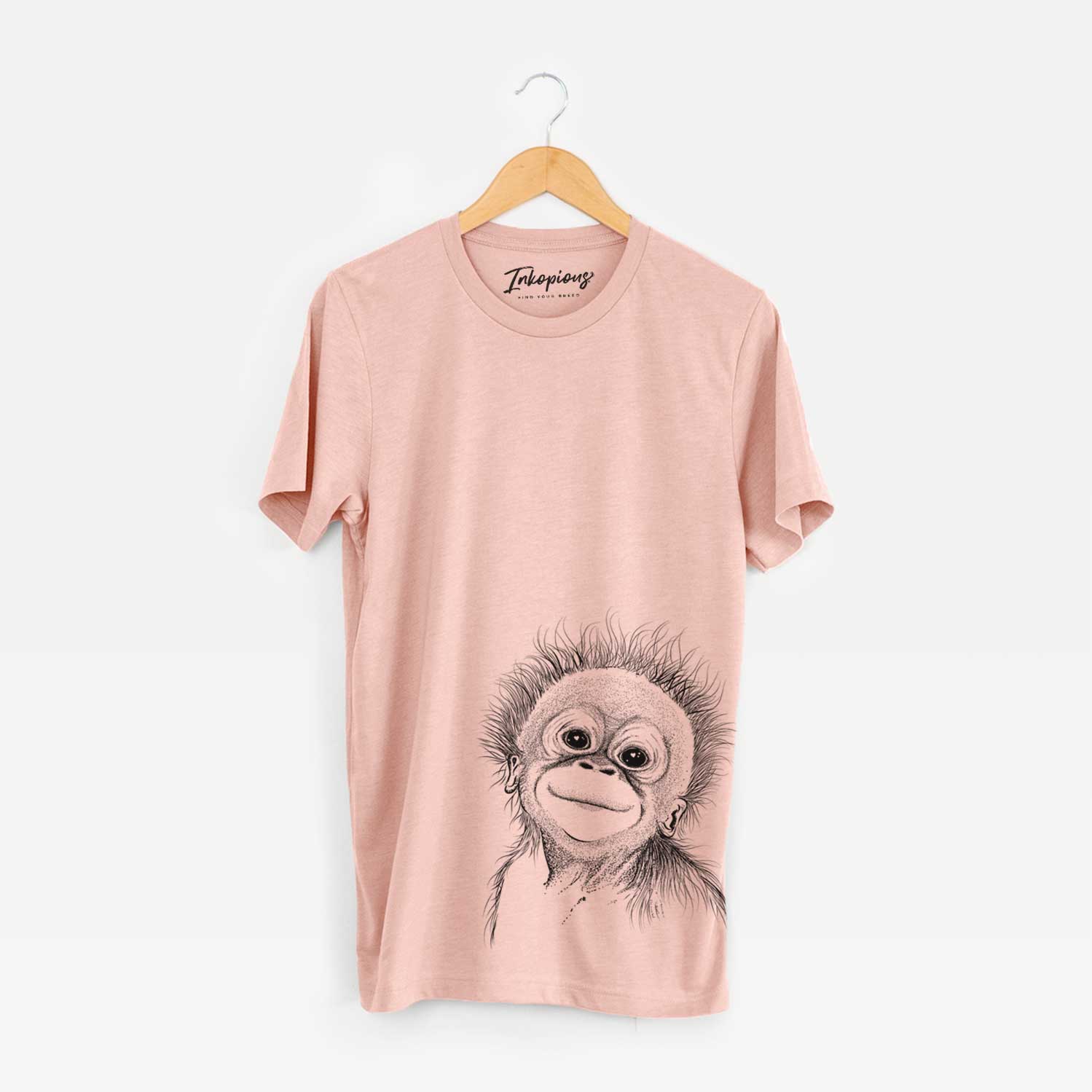 Hand-drawn sketch of Louie the Baby Orangutan on a Peach Bella Canvas Unisex Crewneck