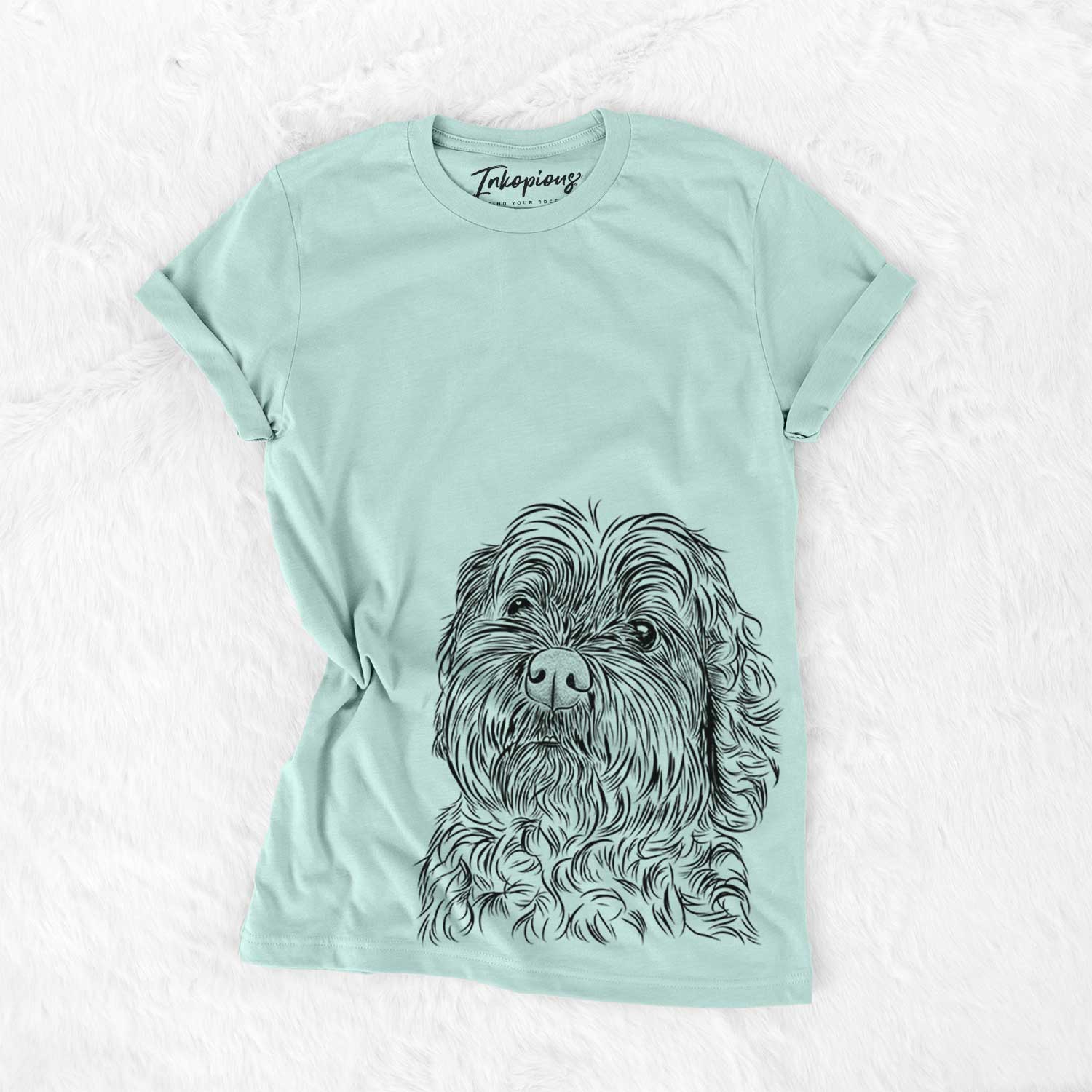 Hand-drawn sketch of Maggie Girl the Cockapoo on a Heather Sage Bella Canvas Unisex Crewneck