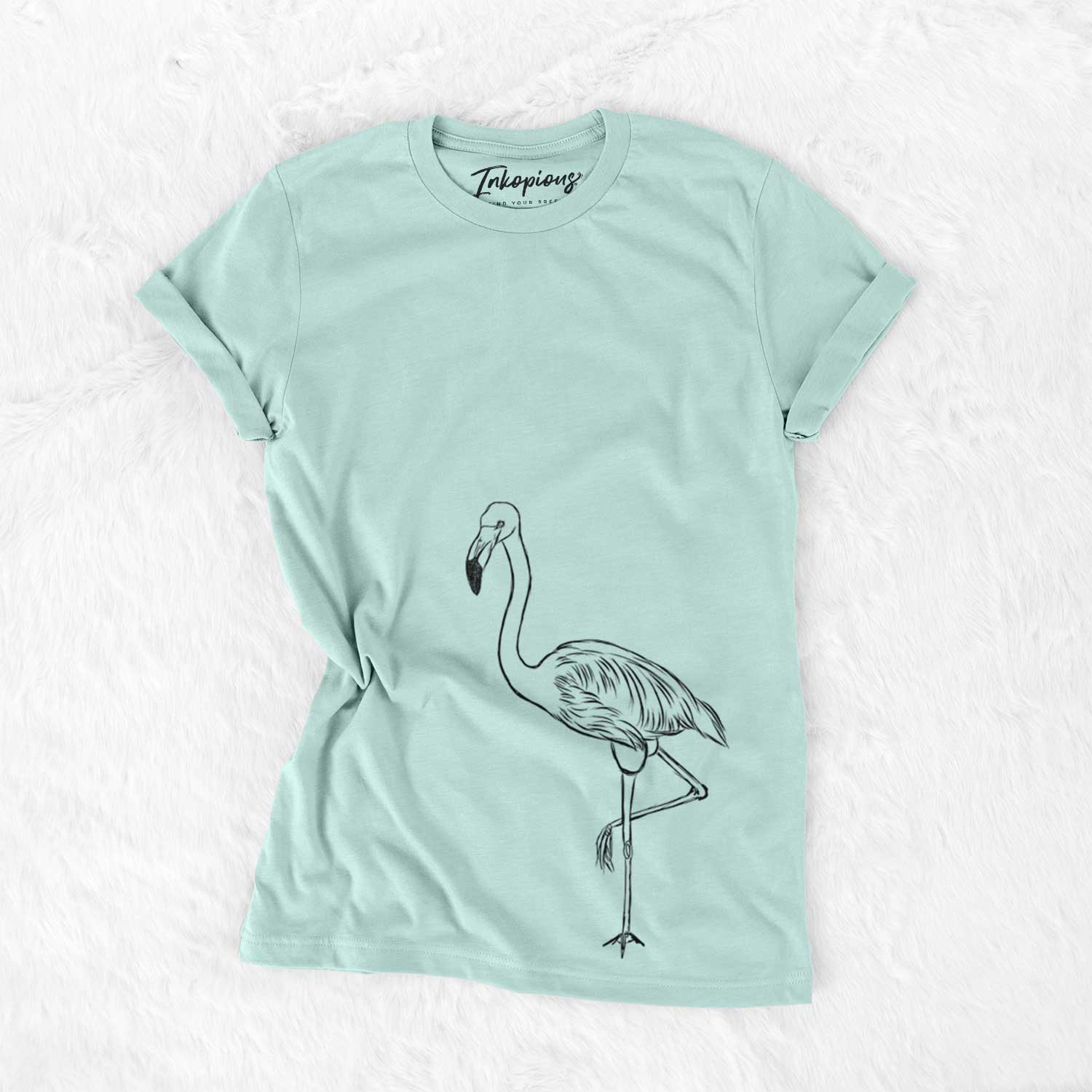 Hand-drawn sketch of Mango the Flamingo on a Heather Sage Unisex crewneck