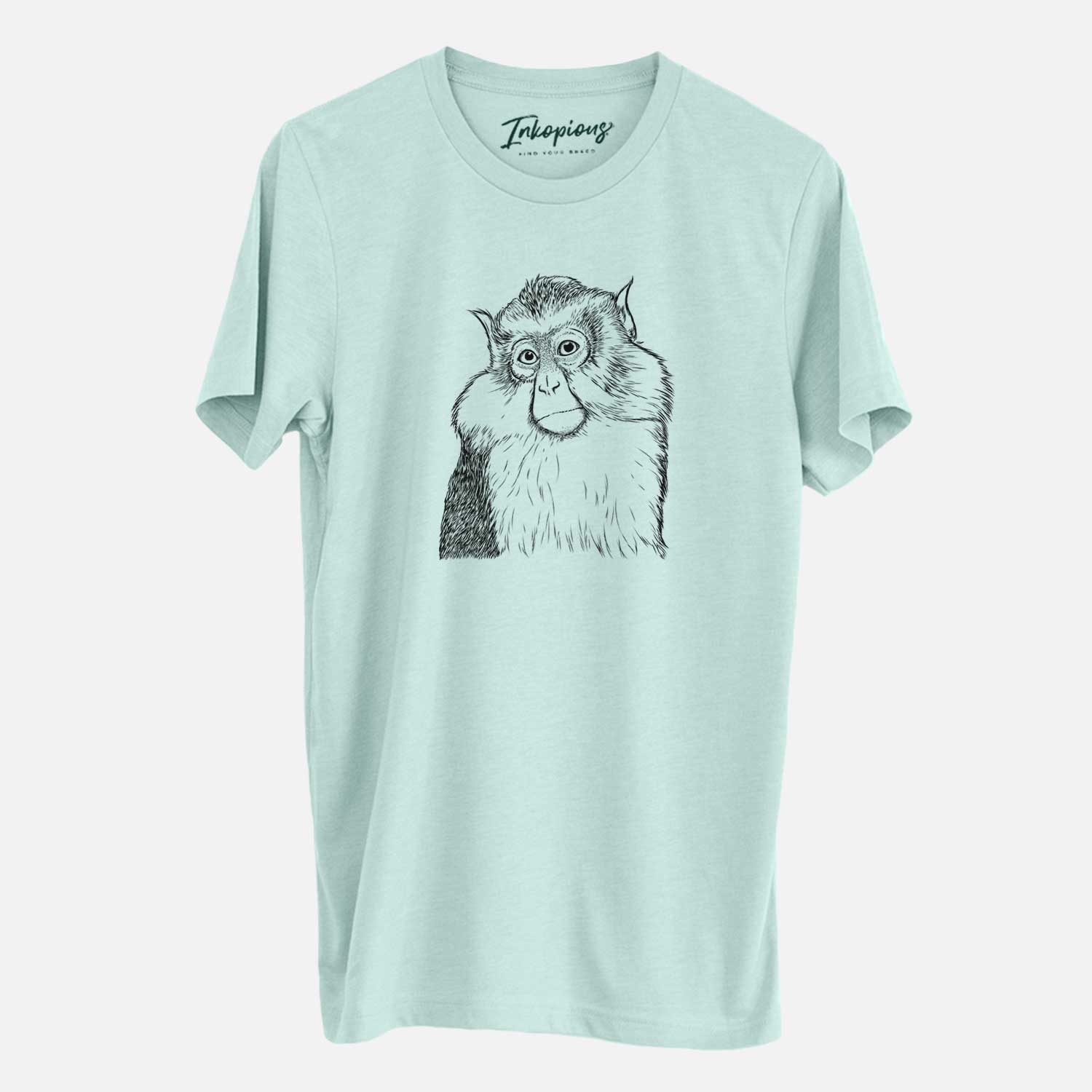 Hand-drawn sketch of Matata the Mona Monkey on a Heather Sage Unisex crewneck