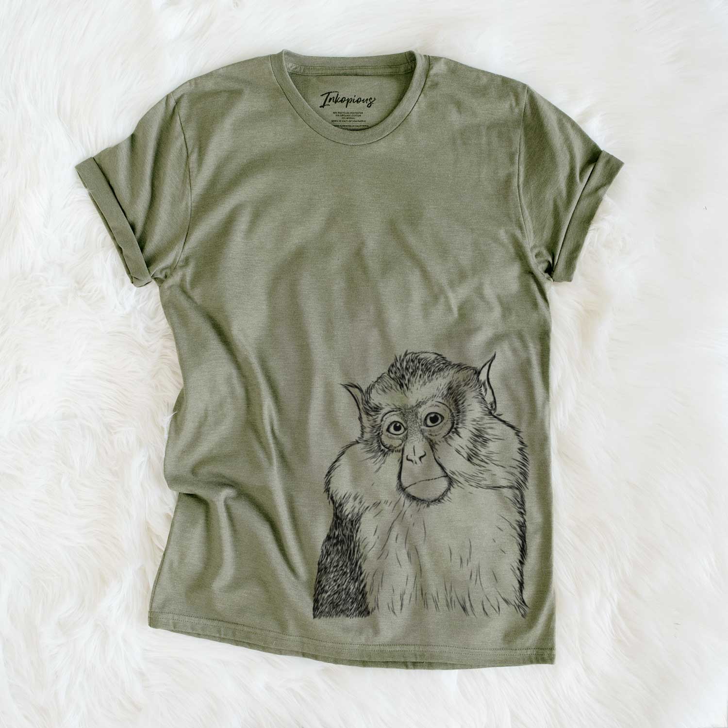 Hand-drawn sketch of Matata the Mona Monkey on an Olive Unisex crewneck