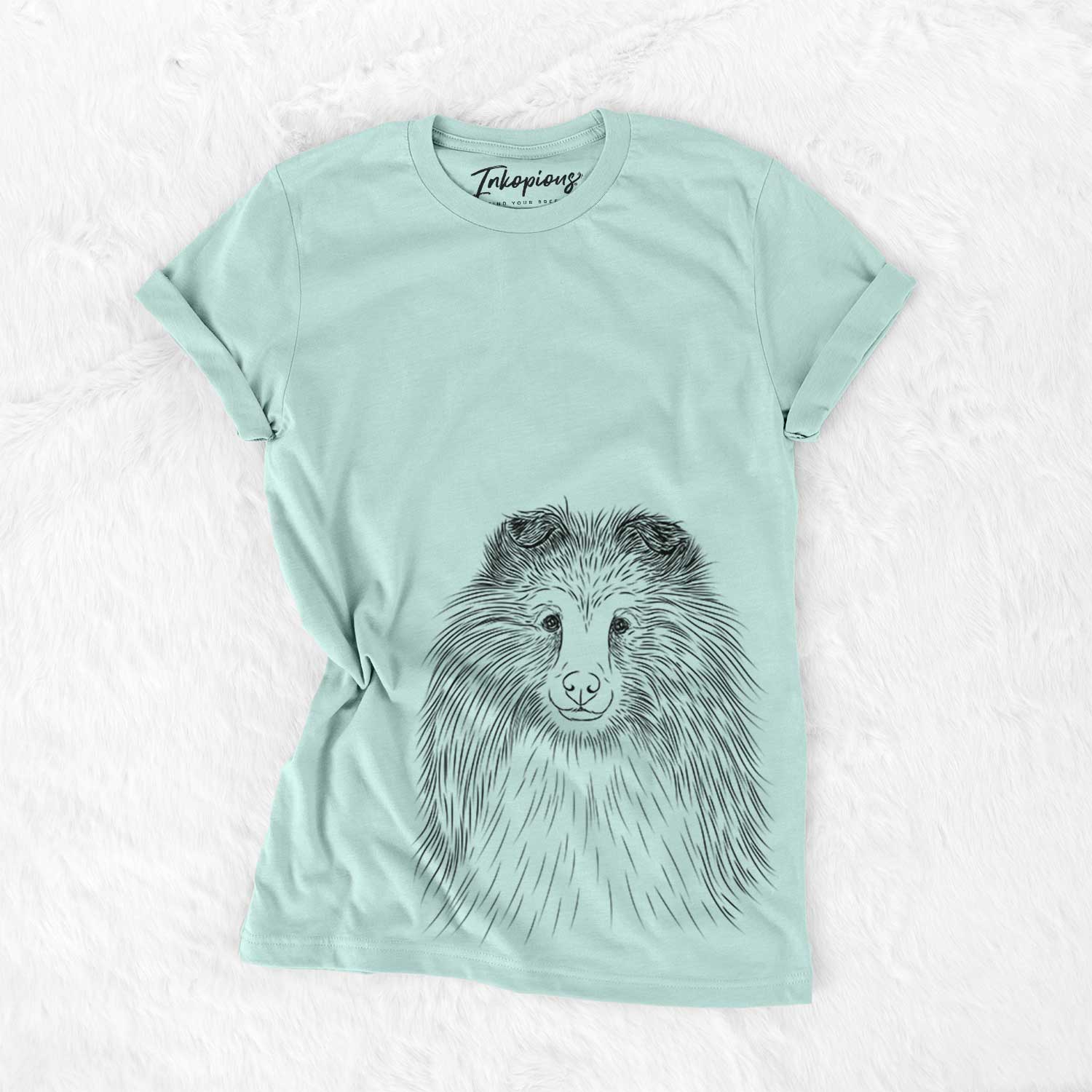 Hand-drawn sketch of Moxie the Shetland Sheepdog on a Heather Sage Bella Canvas Unisex Crewneck