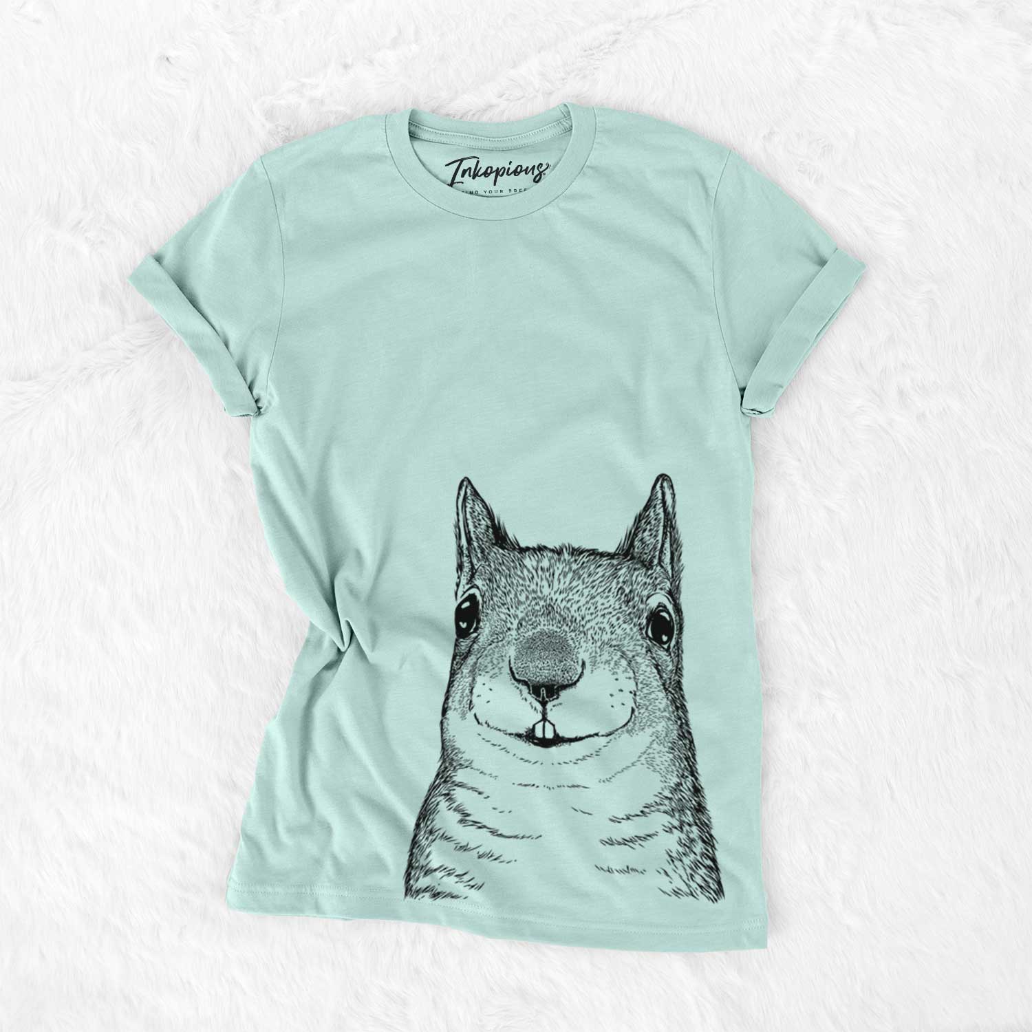 Hand-drawn sketch of Nibbles the Squirrel on a Heather Sage Unisex crewneck