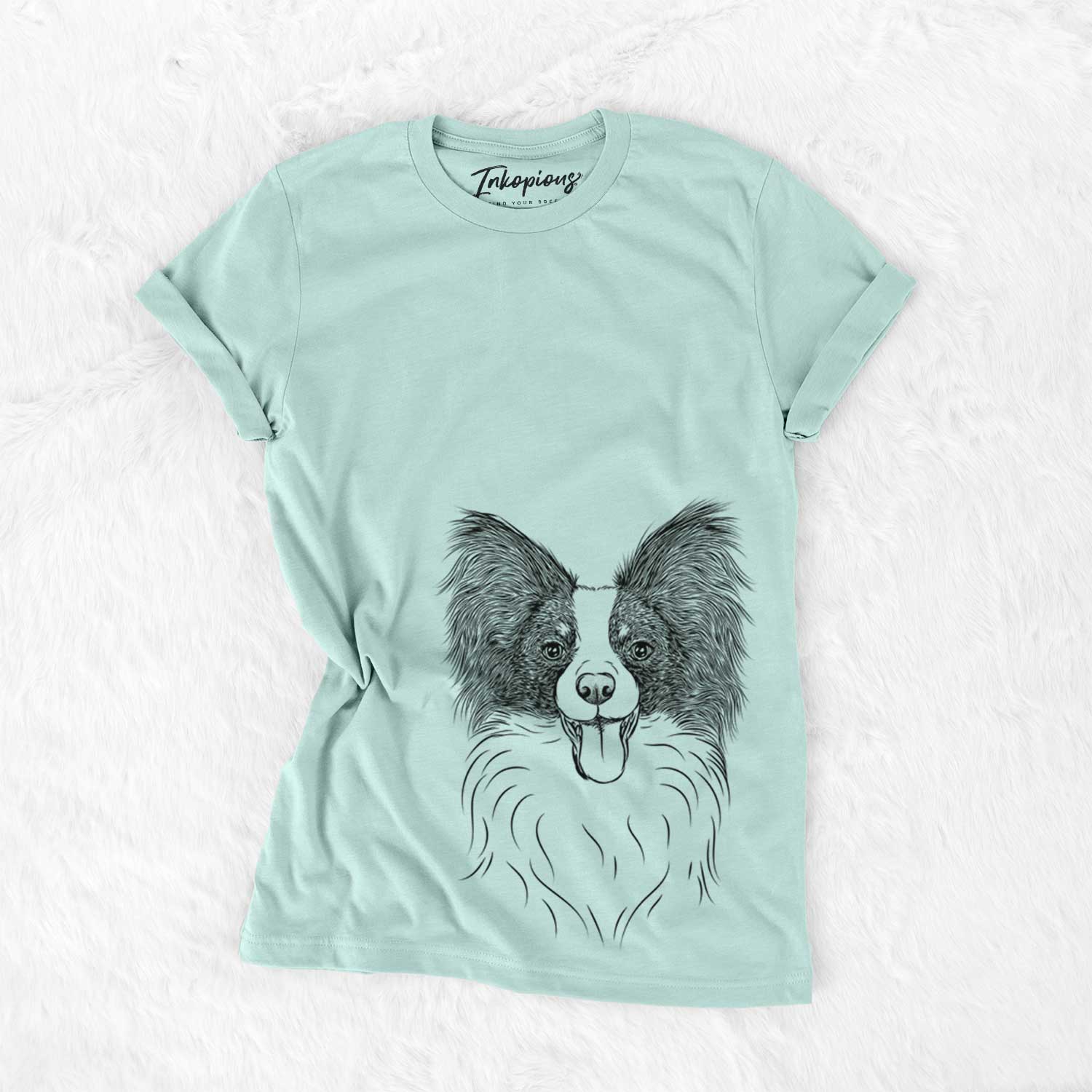 Hand-drawn sketch of Patrick the Papillon on a Heather Sage Unisex crewneck