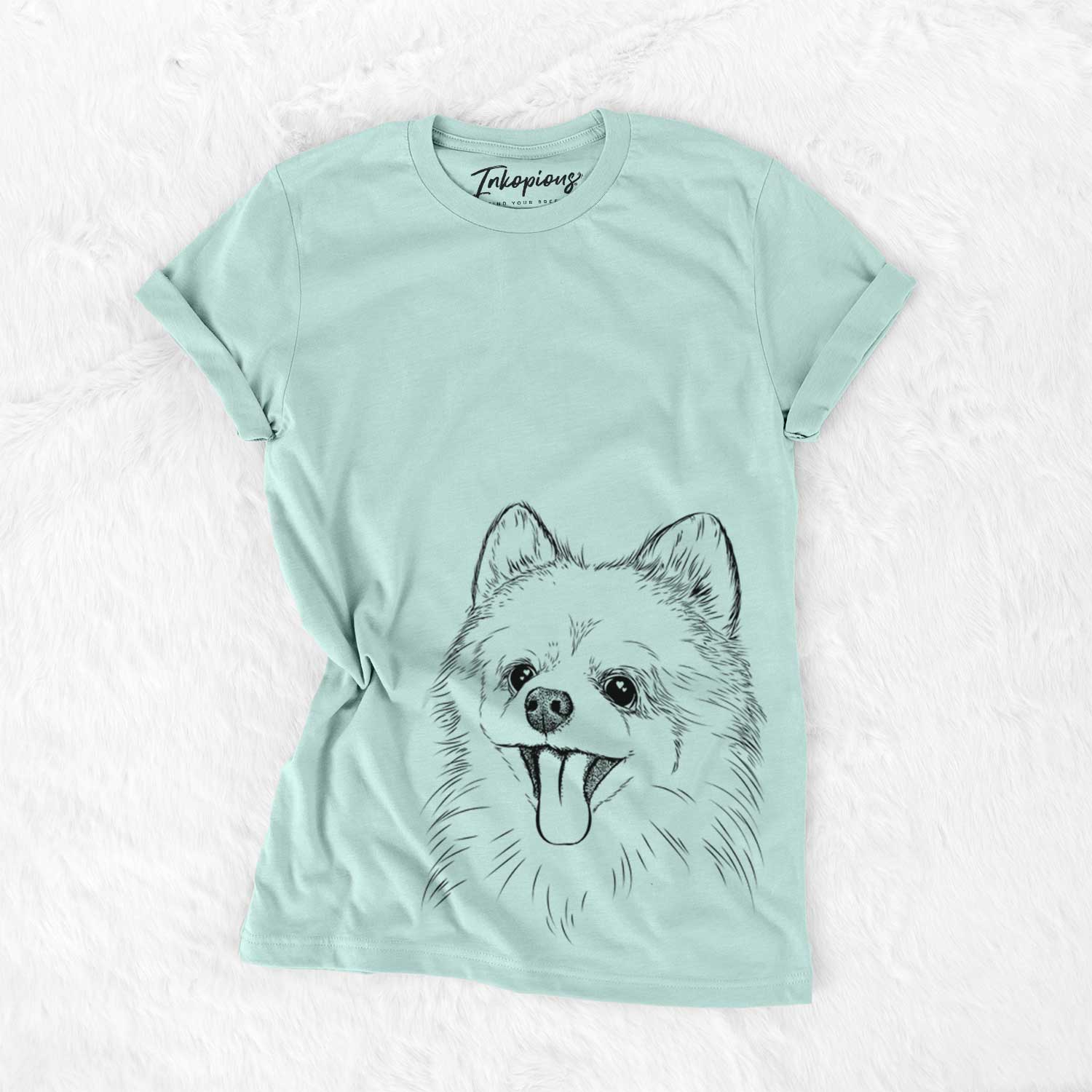 Hand-drawn sketch of Quinn the Pomeranian on a Heather Sage Unisex crewneck