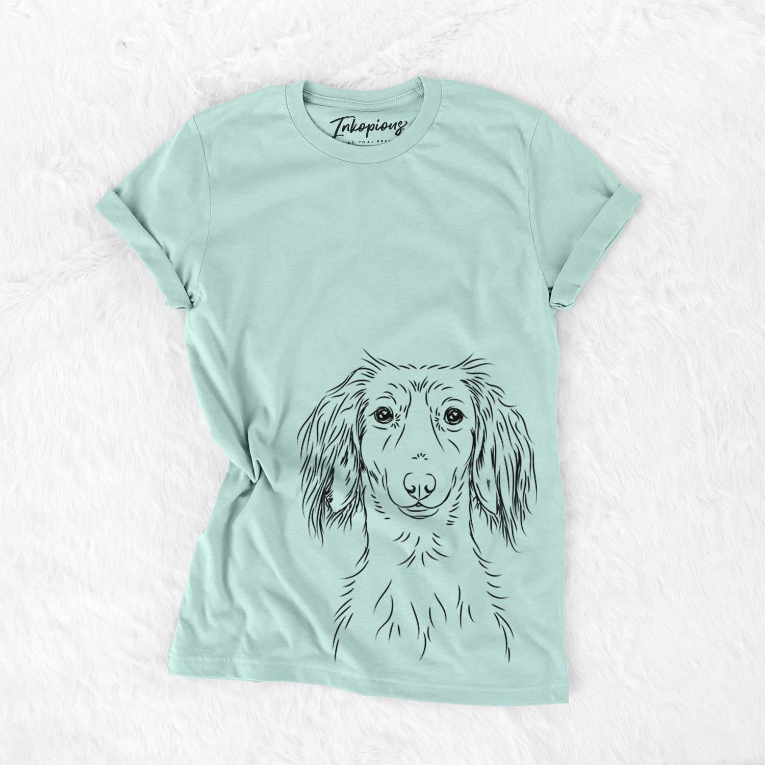 Hand-drawn sketch of Roux the Long Haired Dachshund on a Heather Sage Bella Canvas Unisex Crewneck