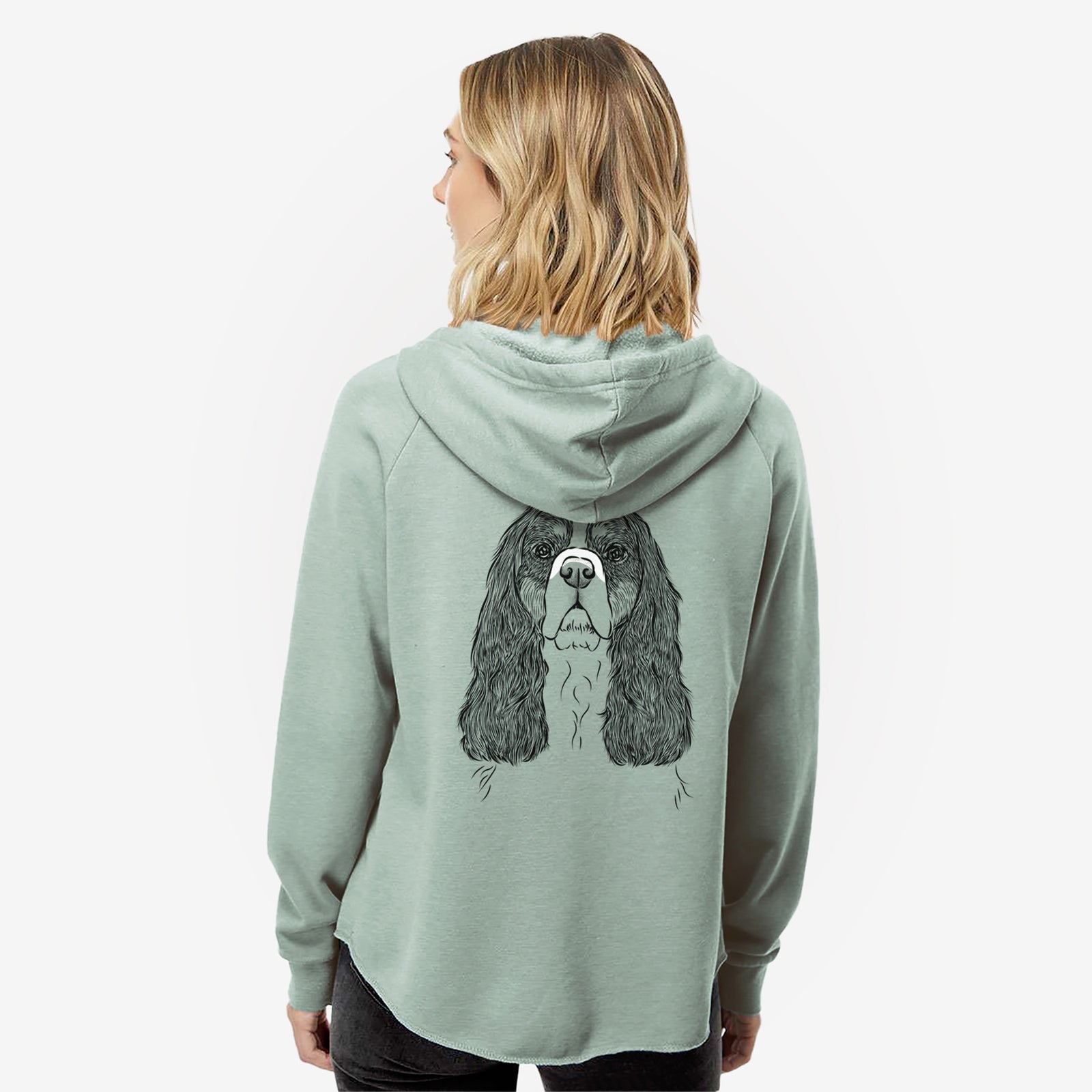 Hand-drawn sketch of Sebastian the Cavalier King Charles Spaniel on a Sage Women's cali wave zip-up sweatshirt