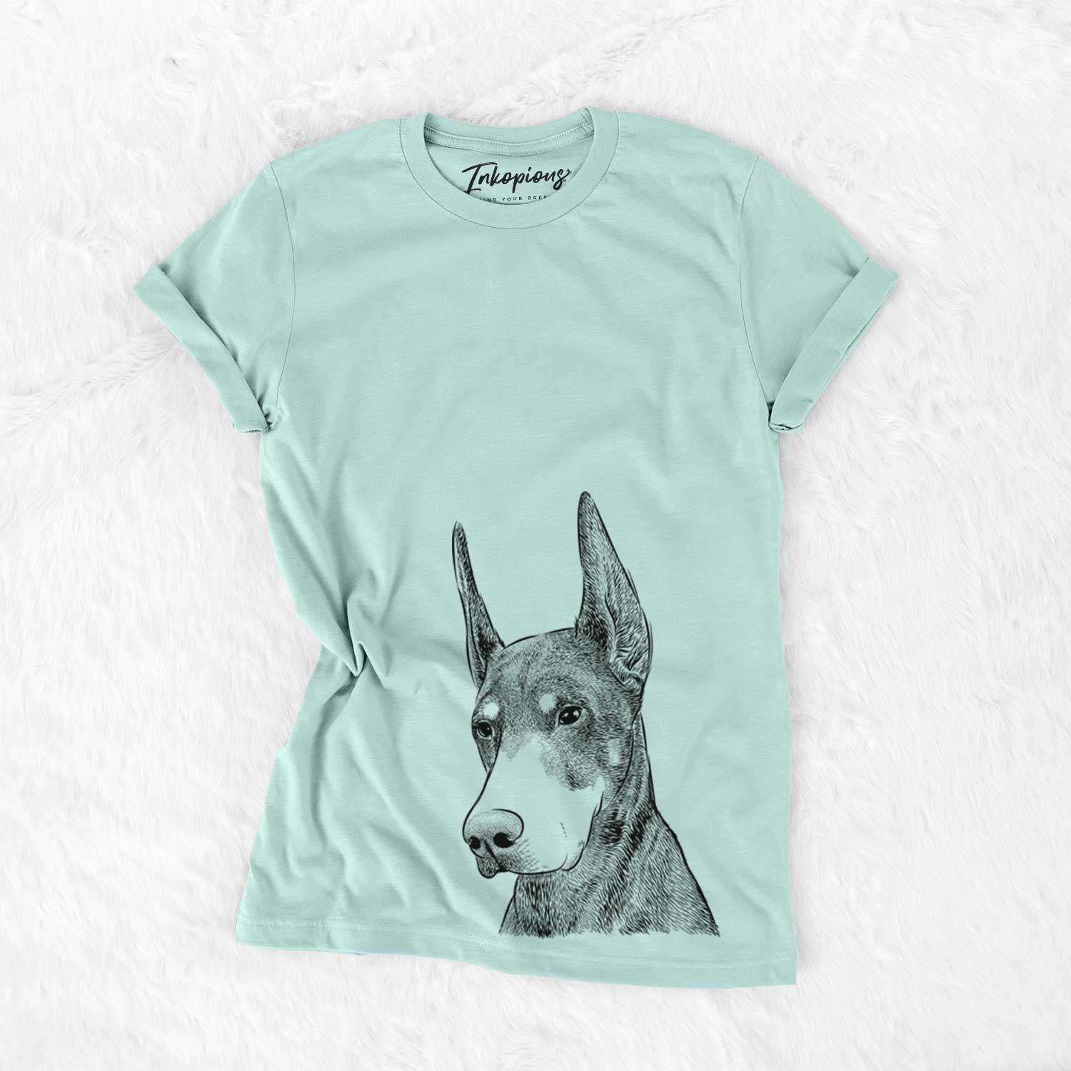 Hand-drawn sketch of Sunny the Doberman Pinscher on a Heather Sage Unisex crewneck