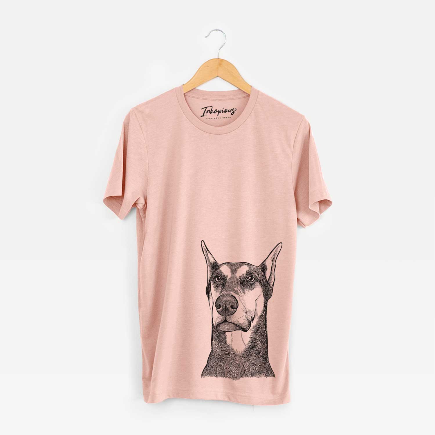 Hand-drawn sketch of Zeus the Doberman Pinscher on a Peach Unisex crewneck