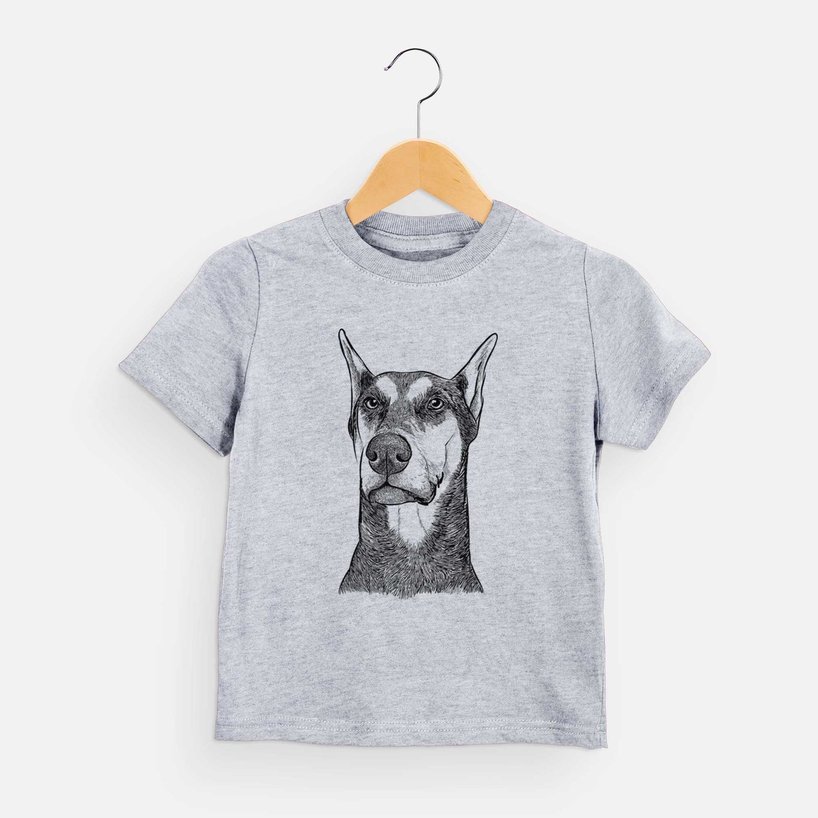 Hand-drawn sketch of Zeus the Doberman Pinscher on a Grey kids' shirt
