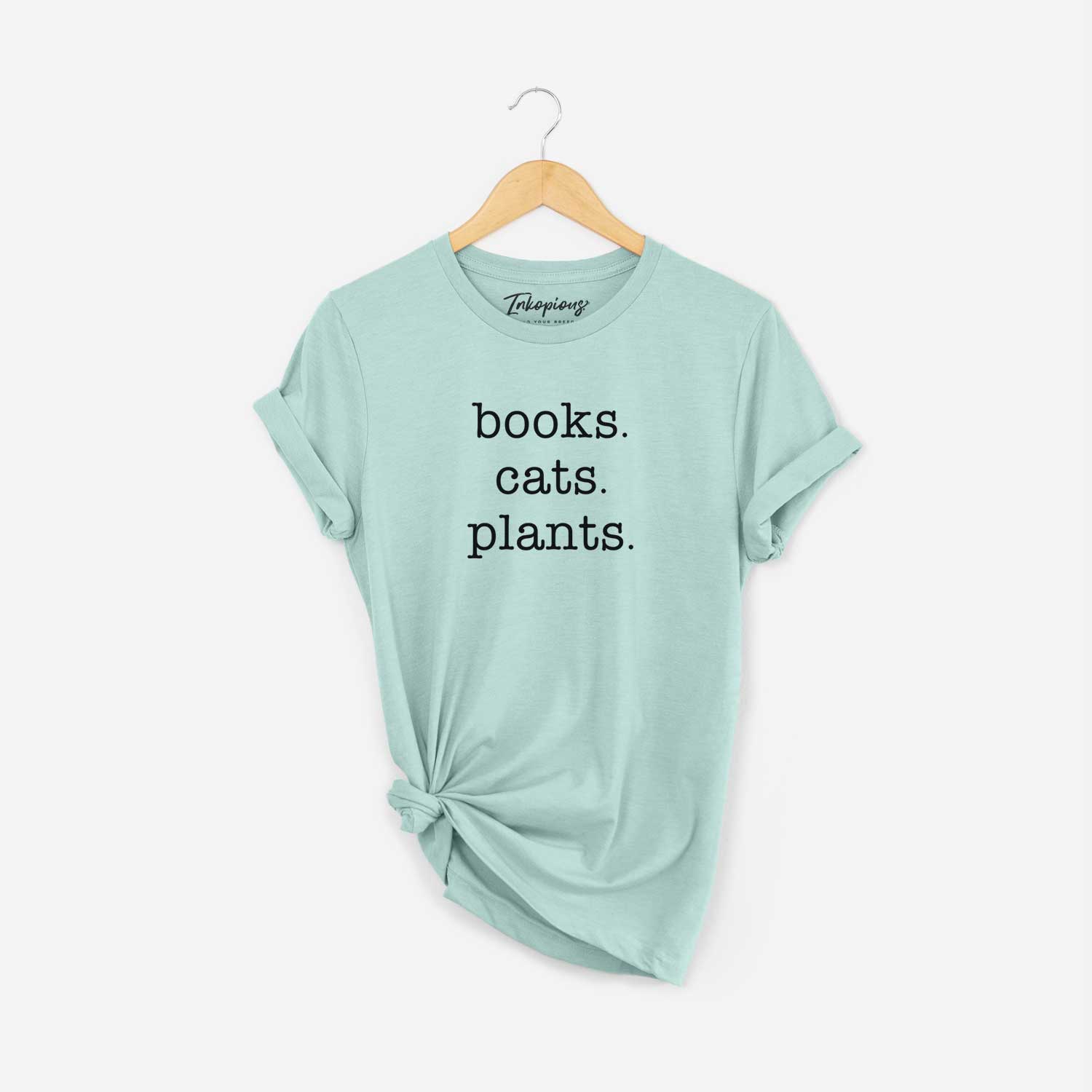 'books. cats. plants' design on a Heather Sage Unisex crewneck