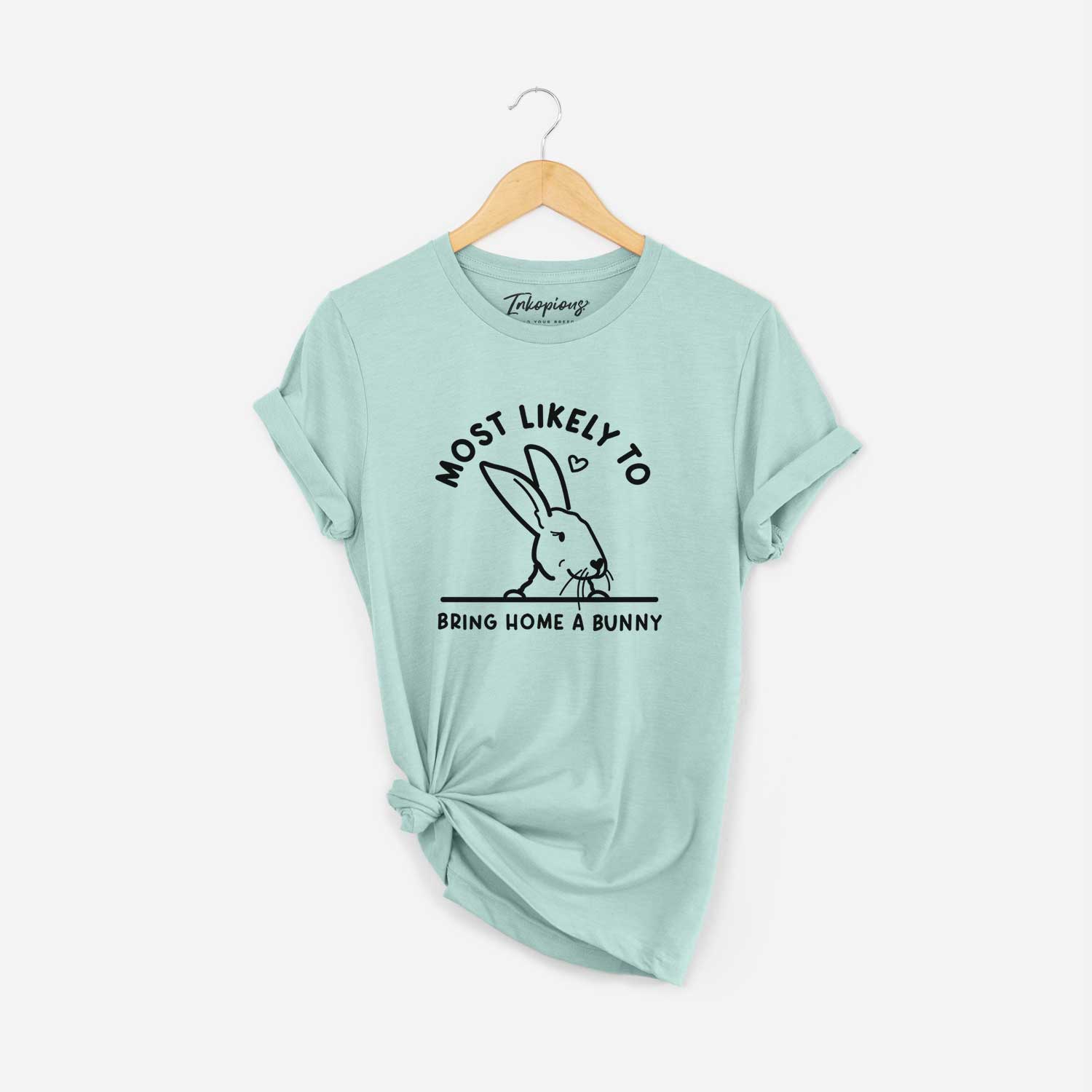 'Most Likely to Bring Home a Bunny' design on a Heather Sage Unisex crewneck
