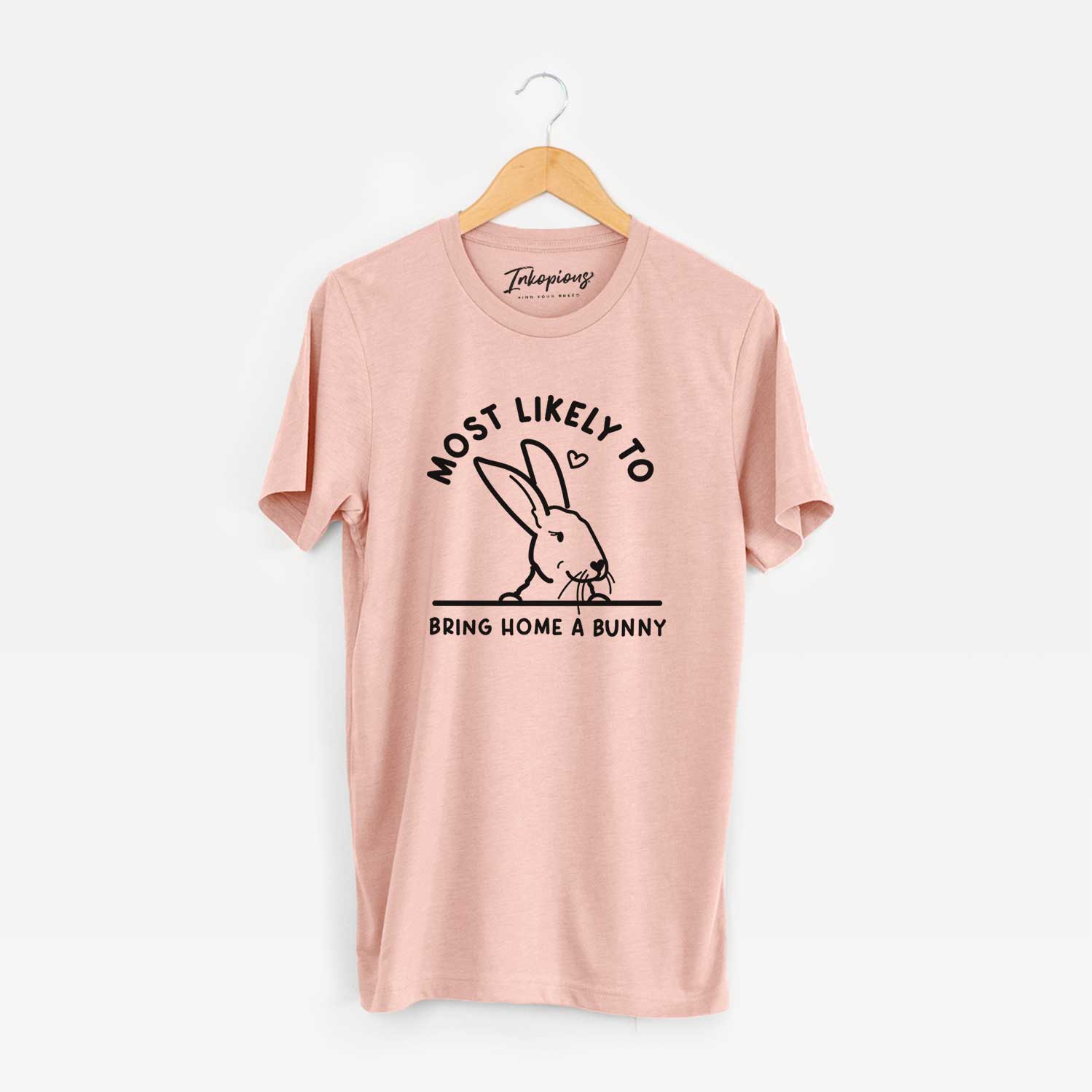 'Most Likely to Bring Home a Bunny' design on a Peach Unisex crewneck