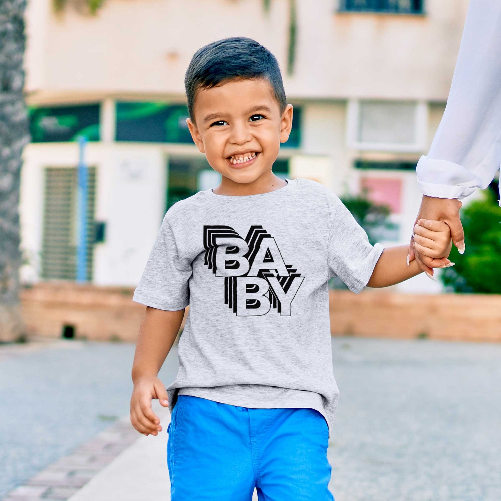'Baby - Electristack Collection' design on a kids' shirt, worn by a boy