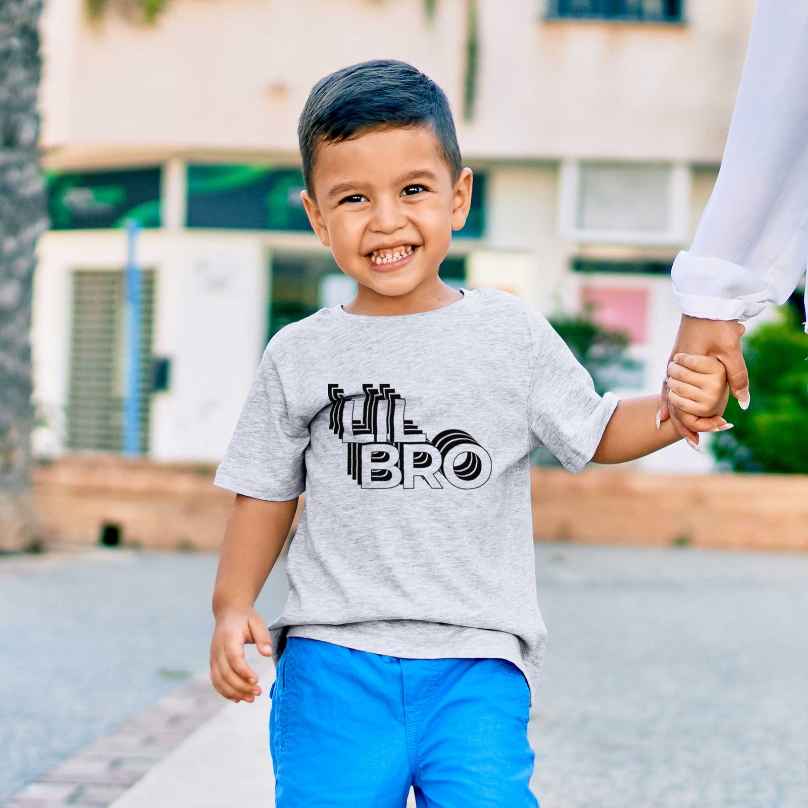 'Lil Bro - Electristack Collection' design on a kids' shirt, worn by a boy
