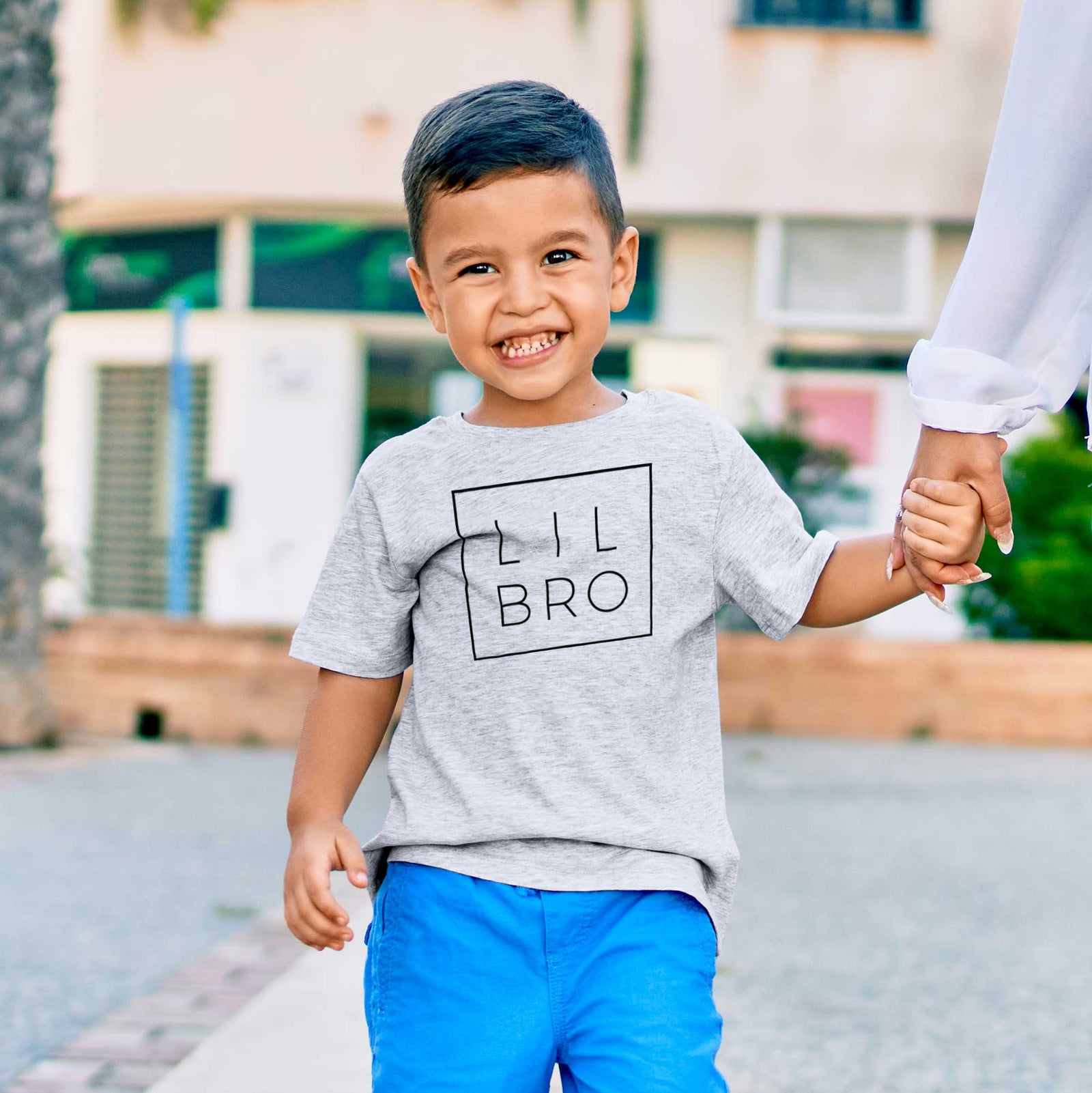 'Lil Bro Boxed' design on a kids' shirt, worn by a boy