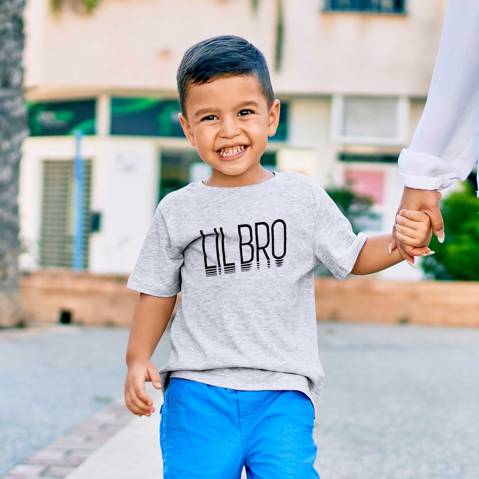 'Lil Bro - Reflections Collection' design on a kids' shirt, worn by a boy