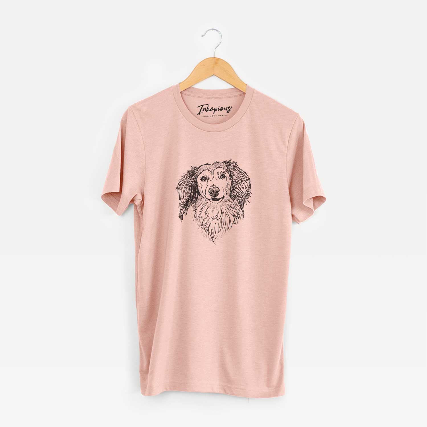Full-body line drawing of Bentley the Long Haired Dachshund on a Peach Unisex crewneck
