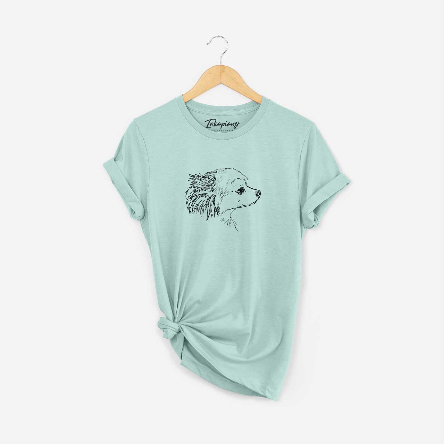 Full-body line drawing of Charles the Pomchi on a Heather Sage Unisex crewneck