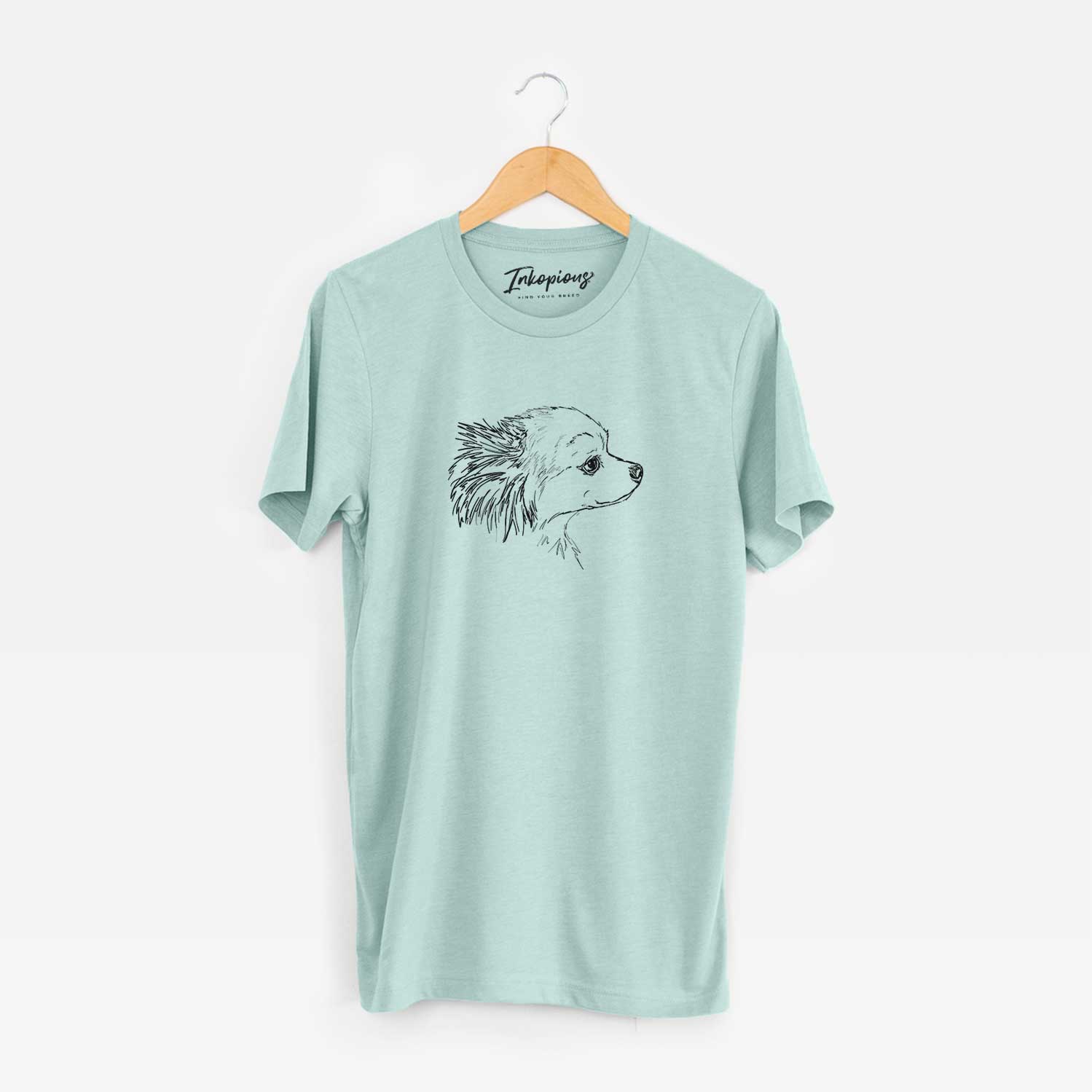 Full-body line drawing of Charles the Pomchi on a Heather Sage Unisex crewneck