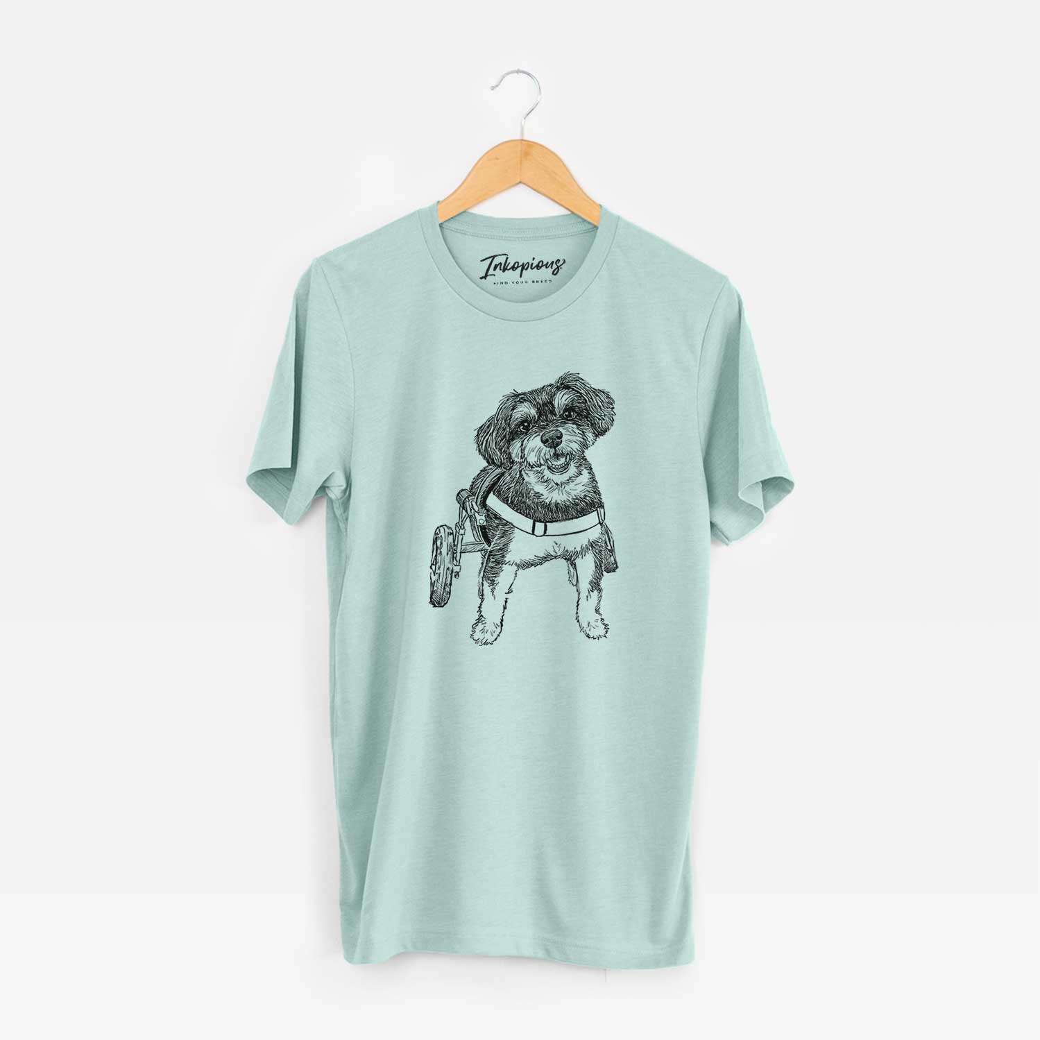 Full-body line drawing of Cobb the Havapoo on a Heather Sage Unisex crewneck