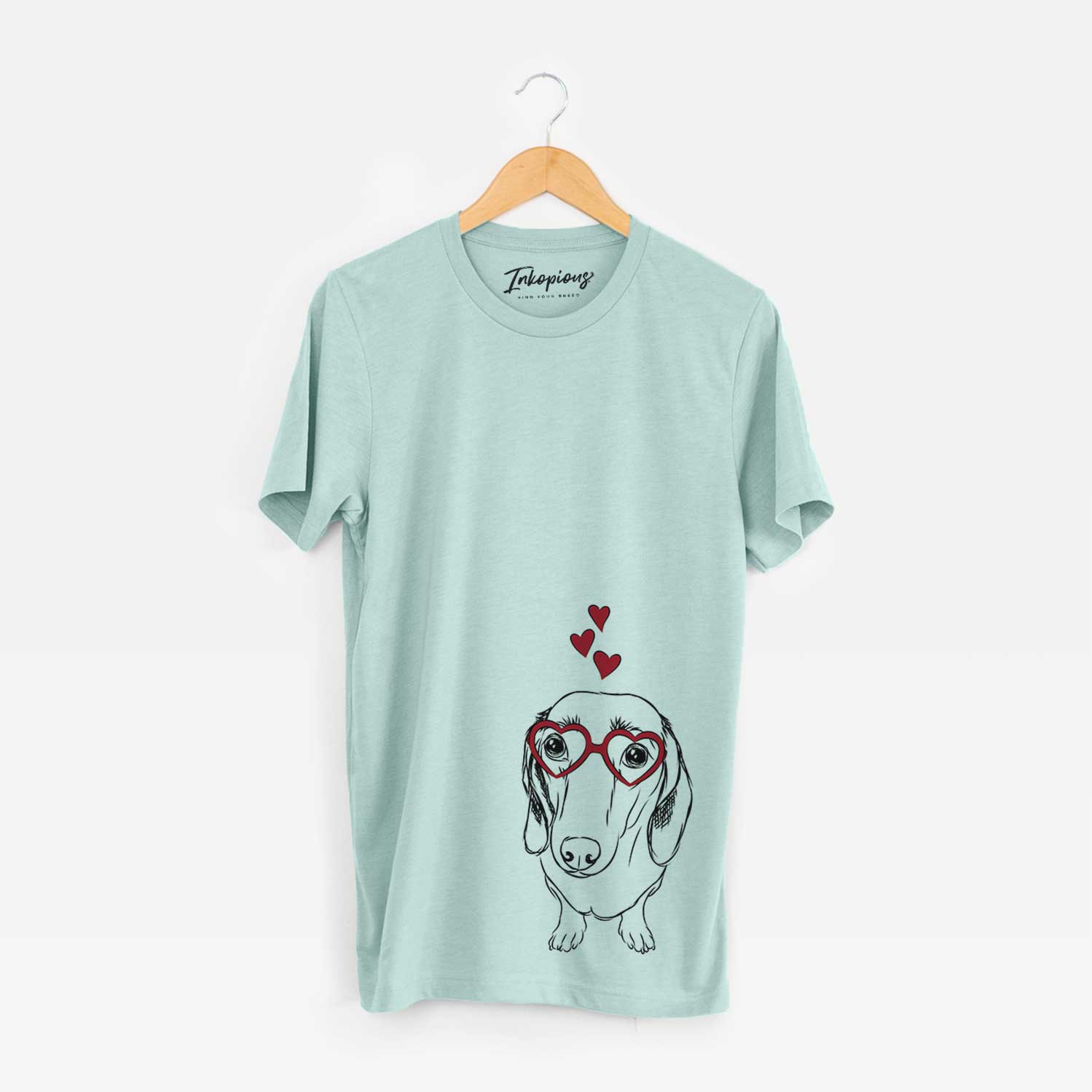 Hand-drawn sketch of Annabelle the Dachshund wearing heart-shaped glasses on a Heather Sage Bella Canvas Unisex Crewneck