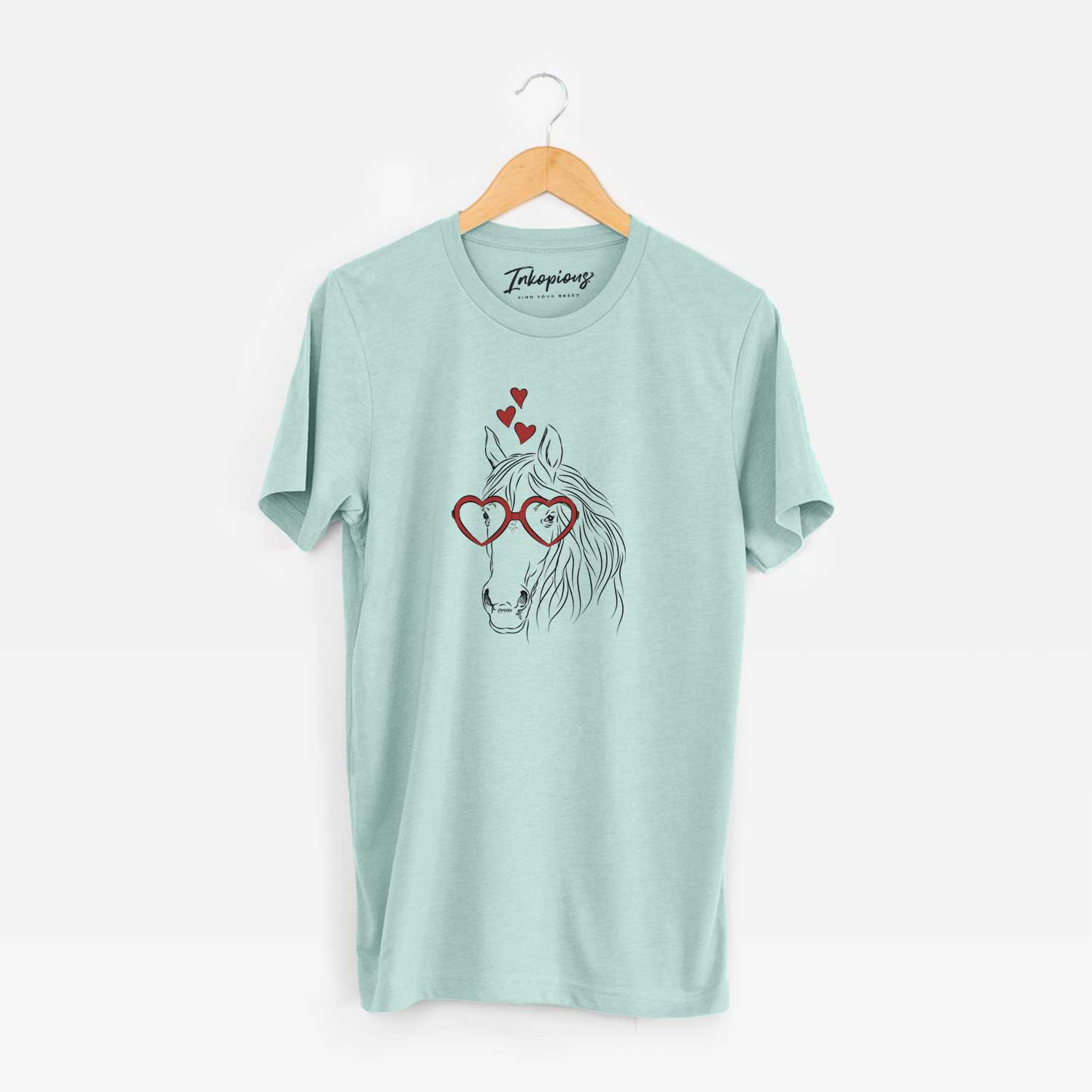 Hand-drawn sketch of Aria the Horse wearing heart-shaped glasses on a Heather Sage Unisex crewneck