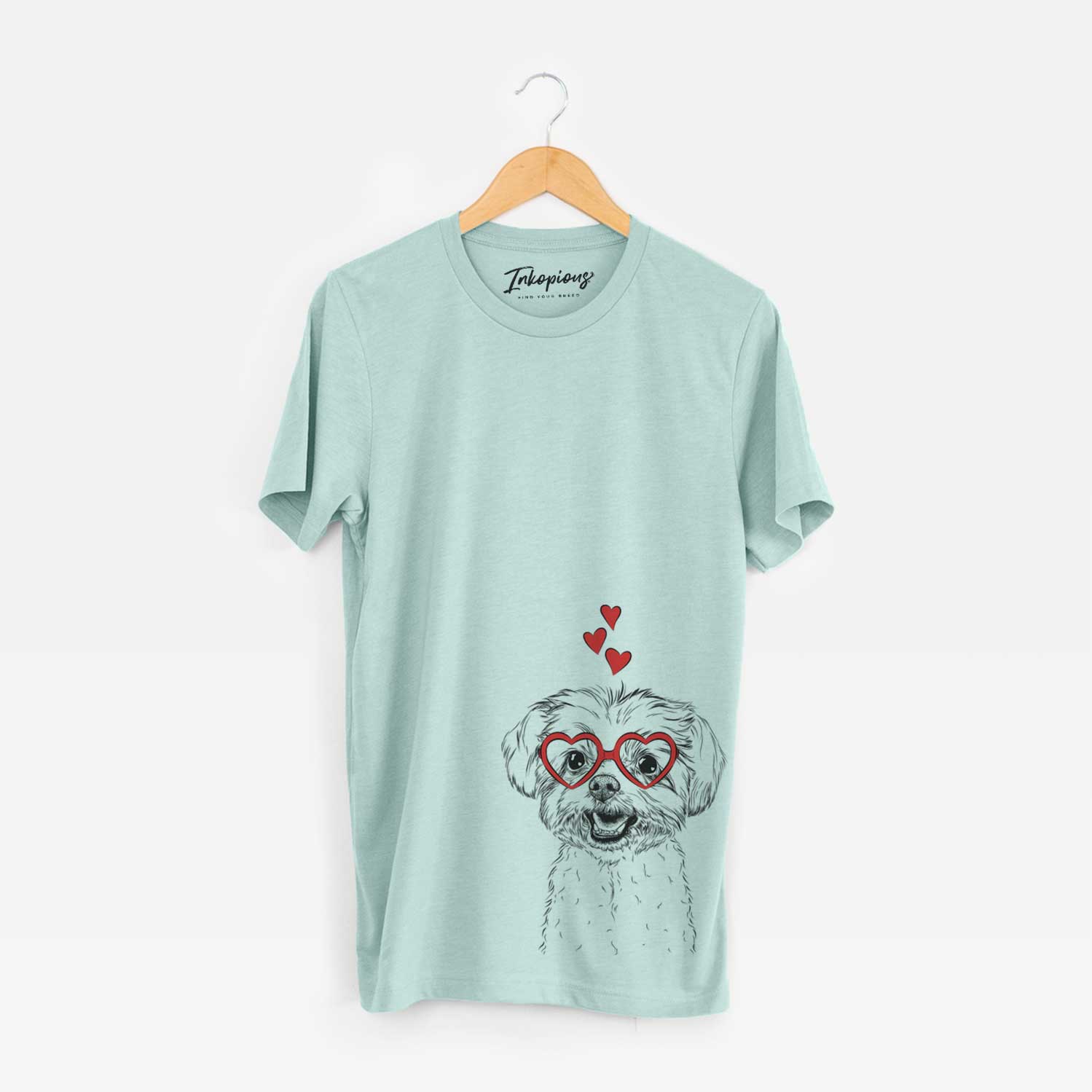 Hand-drawn sketch of Aspen the Morkie wearing heart-shaped glasses on a Heather Sage Unisex crewneck