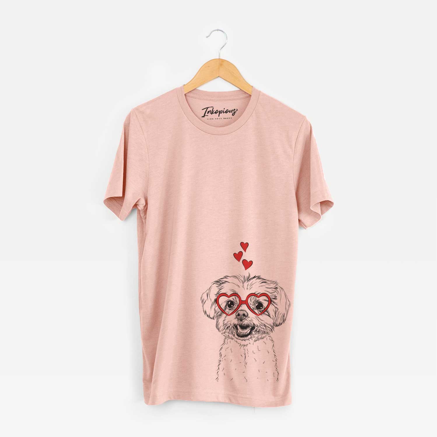 Hand-drawn sketch of Aspen the Morkie wearing heart-shaped glasses on a Peach Unisex crewneck