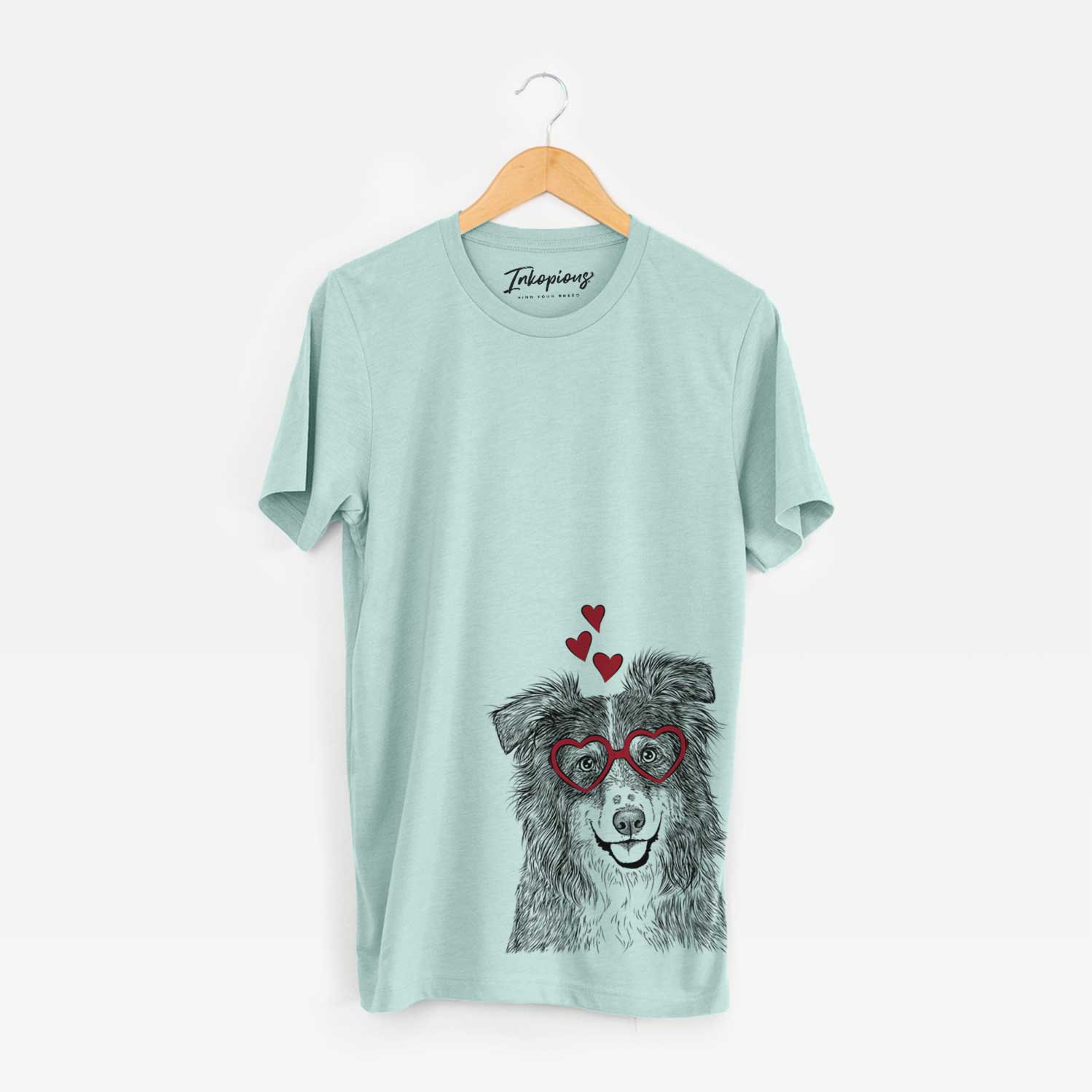 Hand-drawn sketch of Aushe the Australian Shepherd wearing heart-shaped glasses on a Heather Sage Bella Canvas Unisex Crewneck