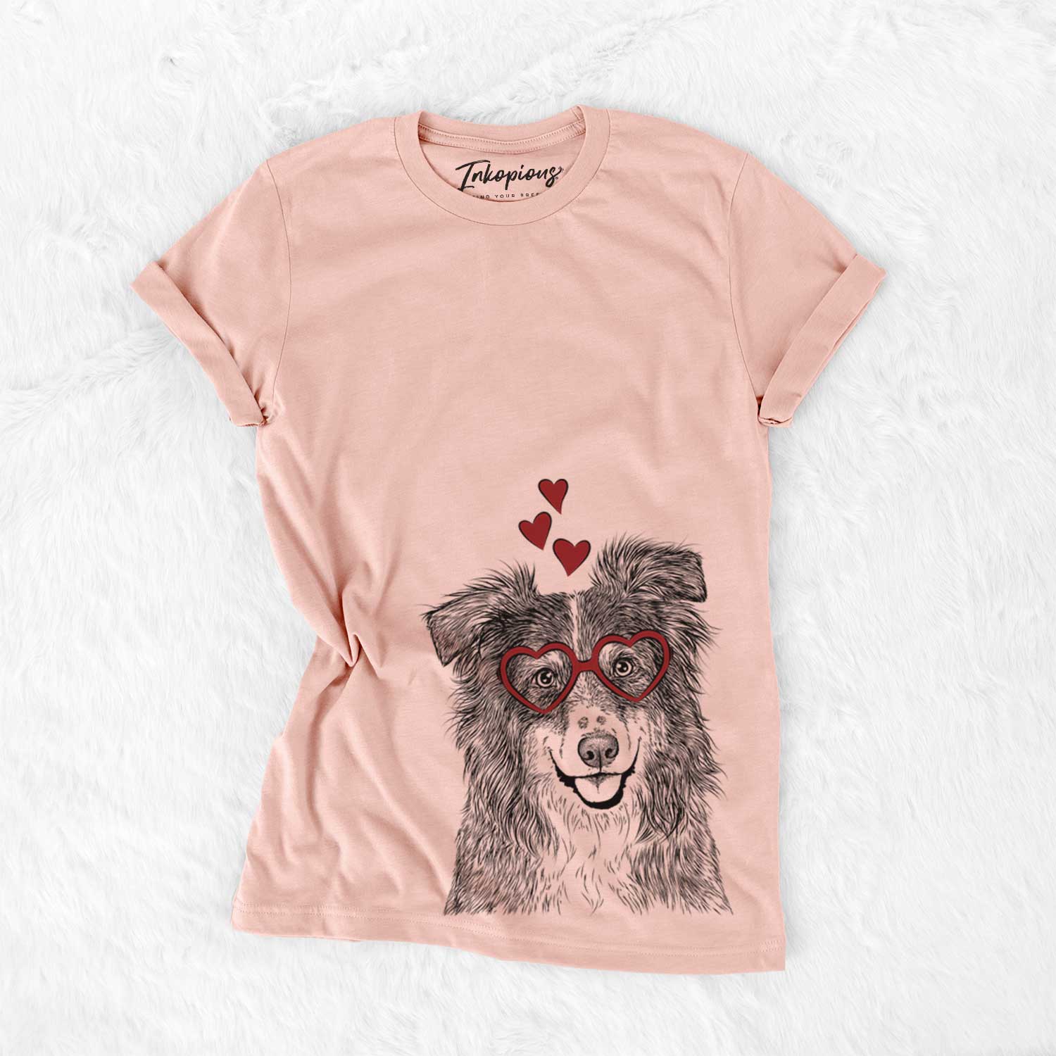 Hand-drawn sketch of Aushe the Australian Shepherd wearing heart-shaped glasses on a Peach Bella Canvas Unisex Crewneck