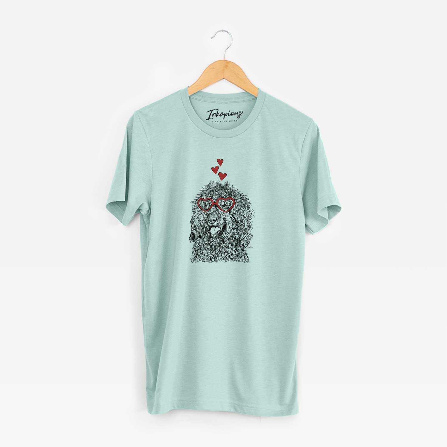 Hand-drawn sketch of Babs the Barbet wearing heart-shaped glasses on a Heather Sage Unisex crewneck